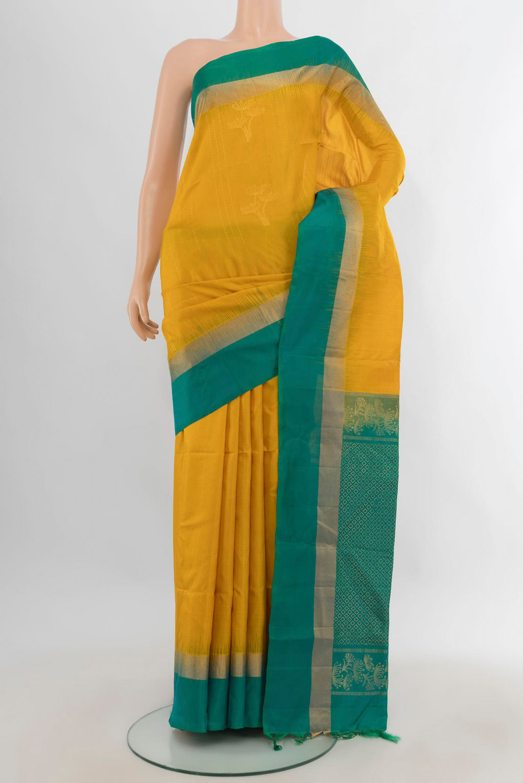 Pure Silk Mustard Soft Saree with Zari Butta on the body and Plain Border.  displayed on a mannequin