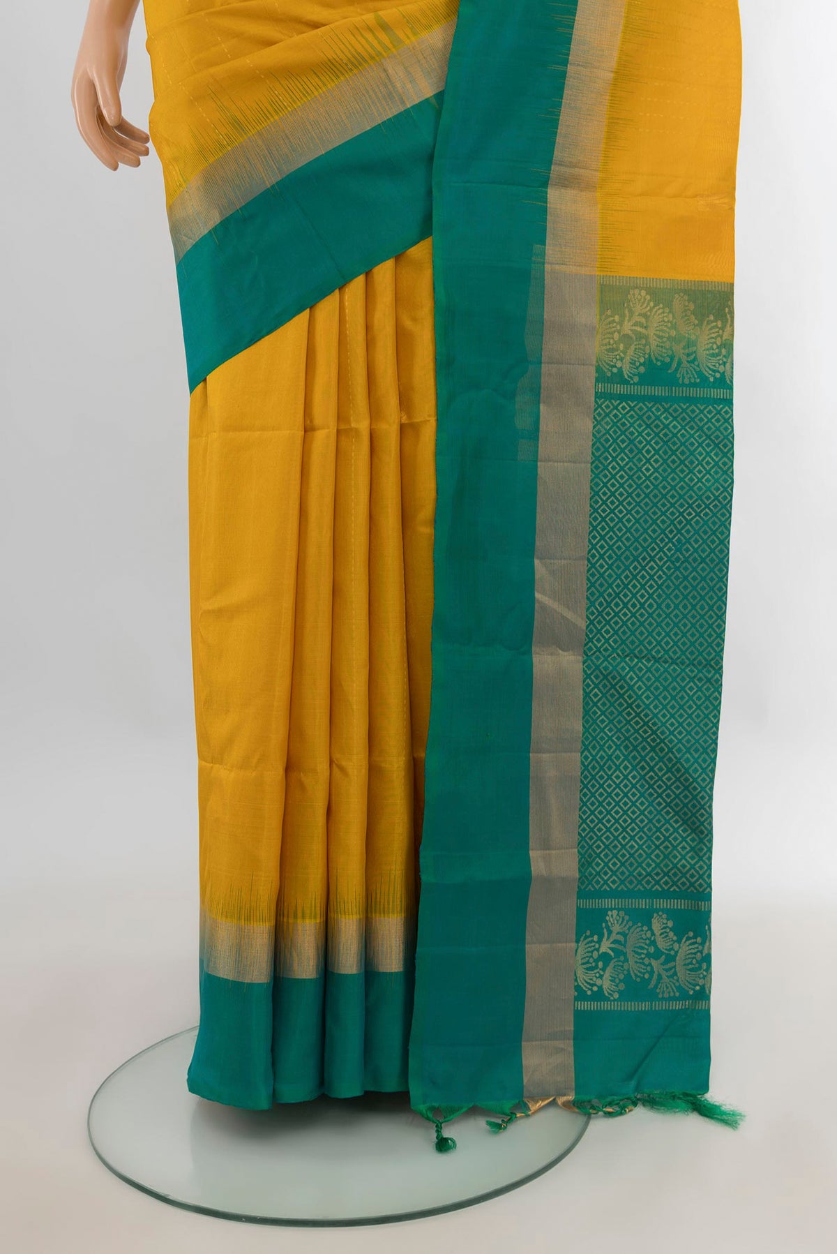 Pleats and pallu of Pure Silk Mustard Soft Saree with Zari Butta on the body and Plain Border. 