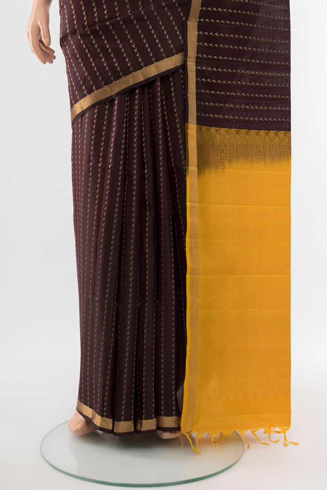 Pleats and pallu of Coffee Brown Soft Silk Saree with Zari Butta on the body and Silk Border. 