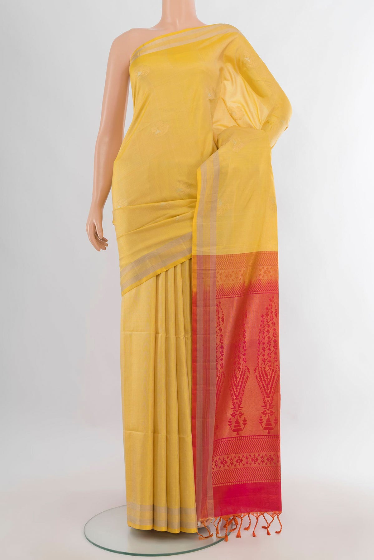 Pure Silk Lemon Yellow Soft Saree with Zari Butta on the body and Zari Border.  displayed on a mannequin