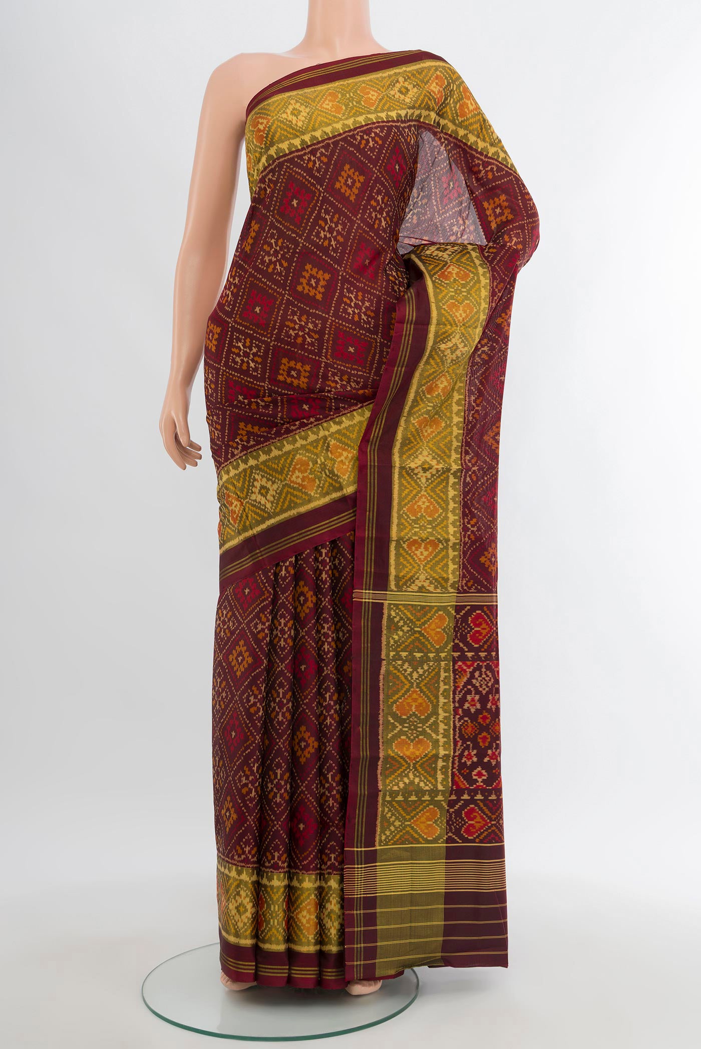 Coffee Brown Rajkot Patola Silk Saree with Pure Ikat on the body and Ikat Border.  displayed on a mannequin