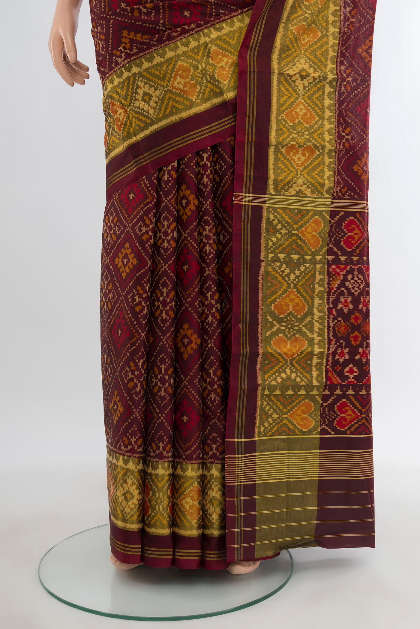 Pleats and pallu of Coffee Brown Rajkot Patola Silk Saree with Pure Ikat on the body and Ikat Border. 