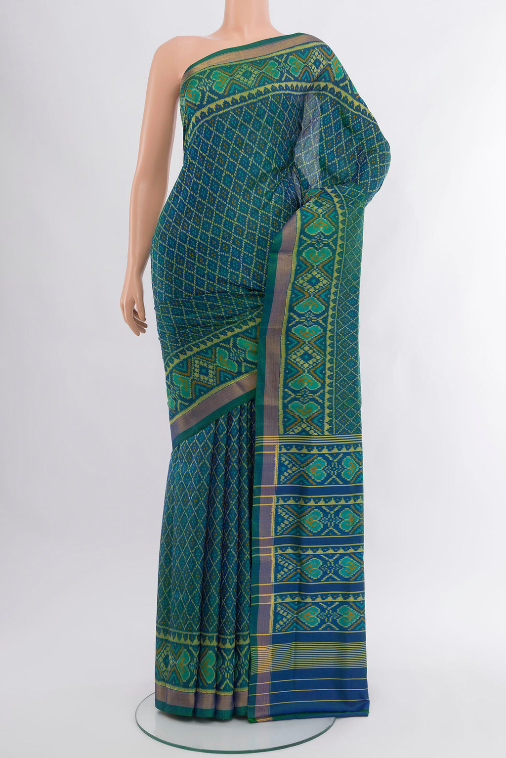 Peacock Blue Dual Tone Rajkot Patola Silk Saree with Pure Ikat on the body and Ikat Border.  displayed on a mannequin