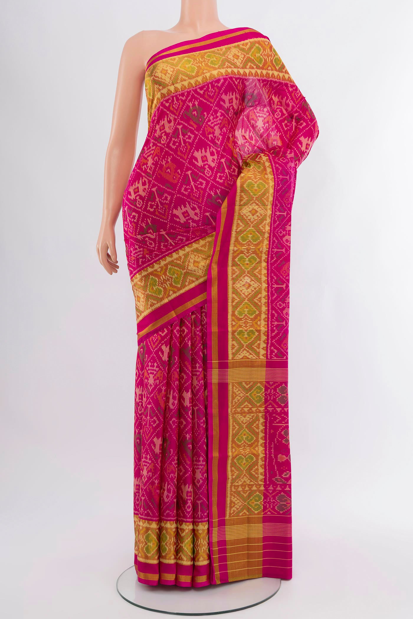 Pink Rajkot Patola Silk Saree with Pure Ikat on the body and Ikat Border.  displayed on a mannequin