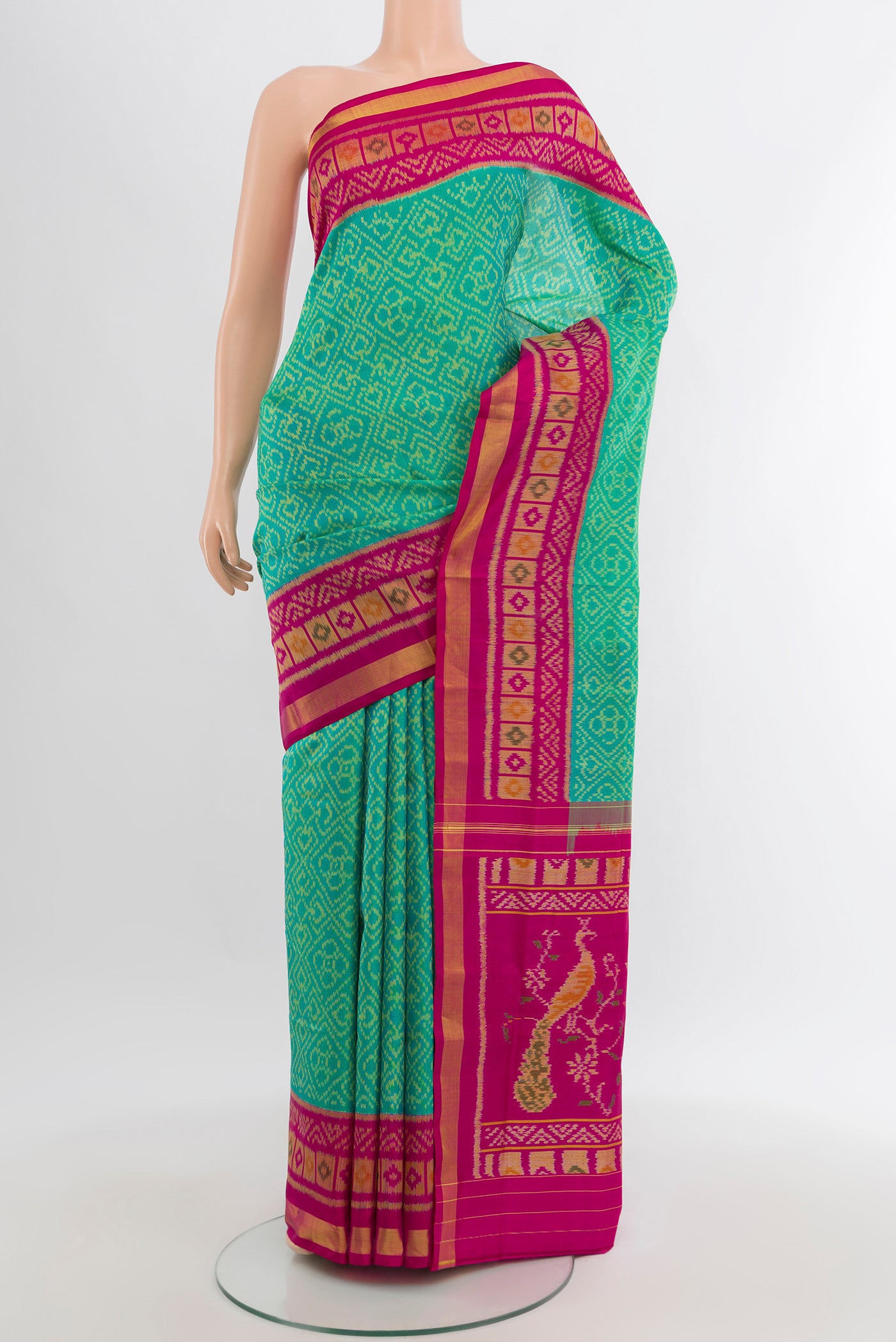 Sea Green Rajkot Patola Silk Saree with Pure Ikat on the body and Ikat Border.  displayed on a mannequin