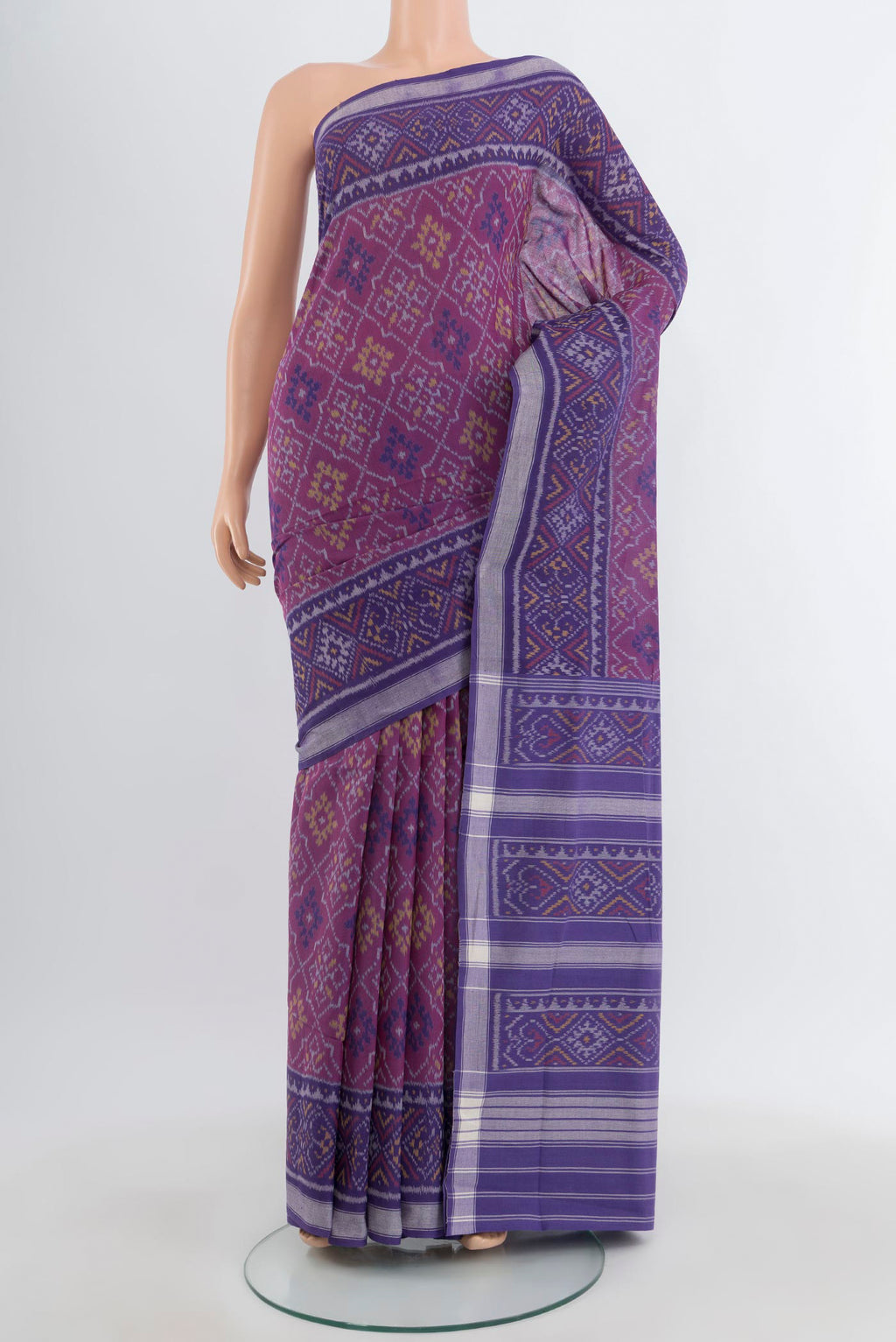 Purple Rajkot Patola Silk Saree with Ikat design on the body and Ikat Border.  displayed on a mannequin