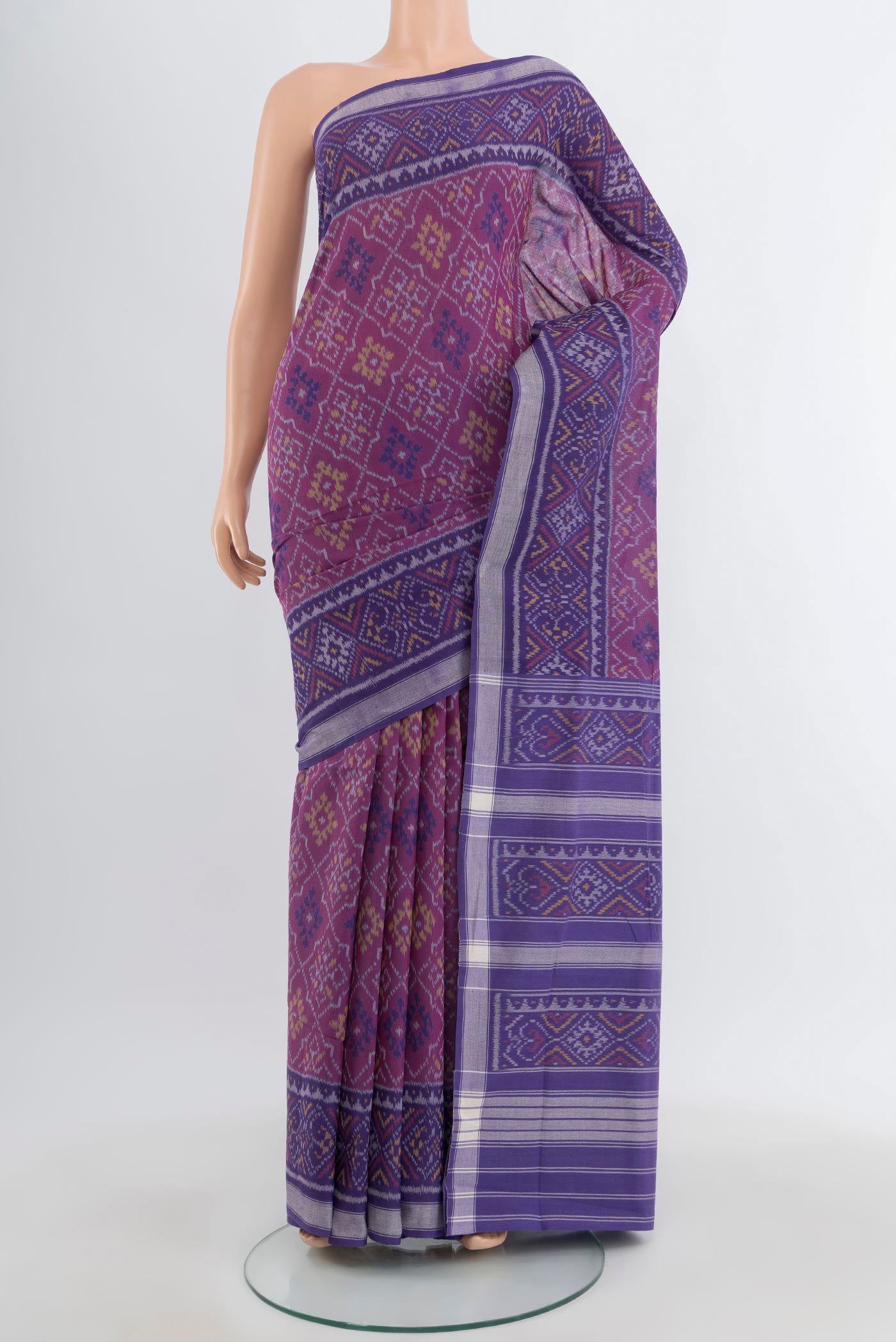 Purple Rajkot Patola Silk Saree with Ikat design on the body and Ikat Border.  displayed on a mannequin