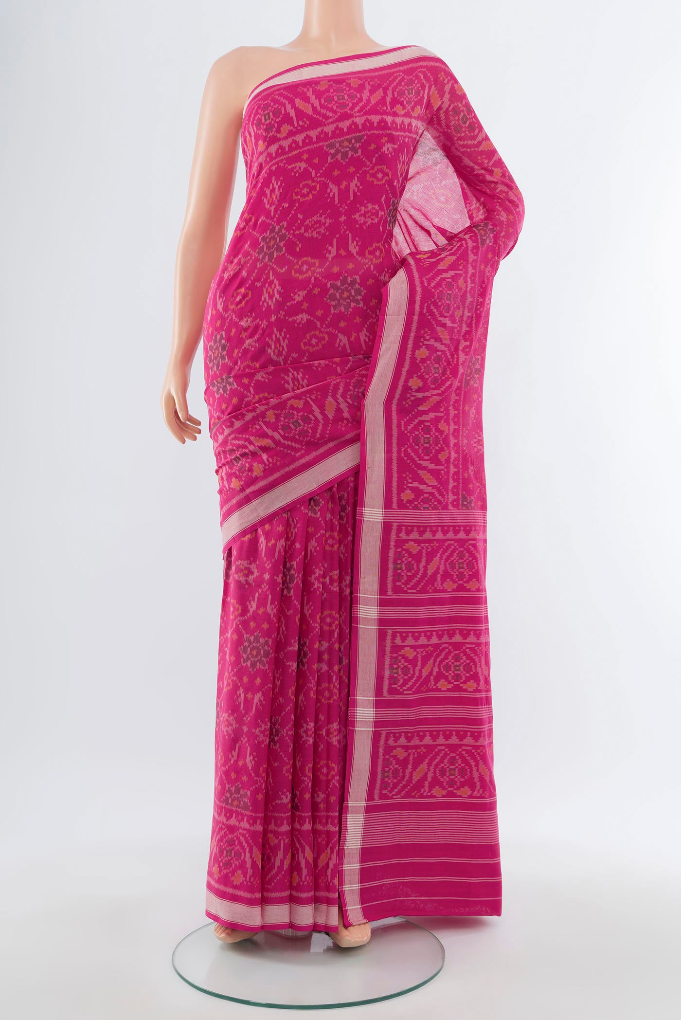Rani Pink Rajkot Patola Silk Saree with Ikat design on the body and Zari Border.  displayed on a mannequin