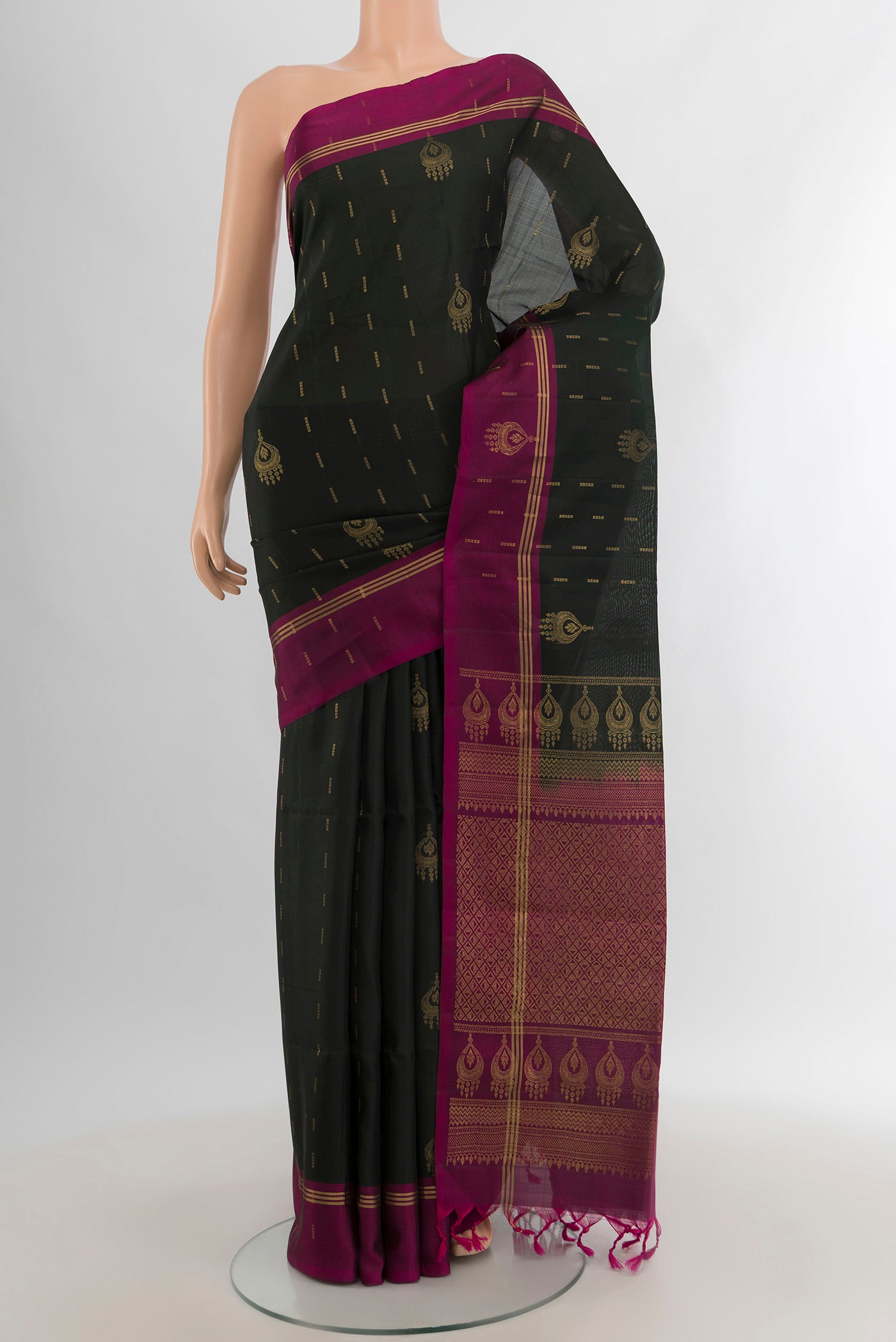 Black Soft Silk Saree with Zari Butta on the body and Plain Border.  displayed on a mannequin