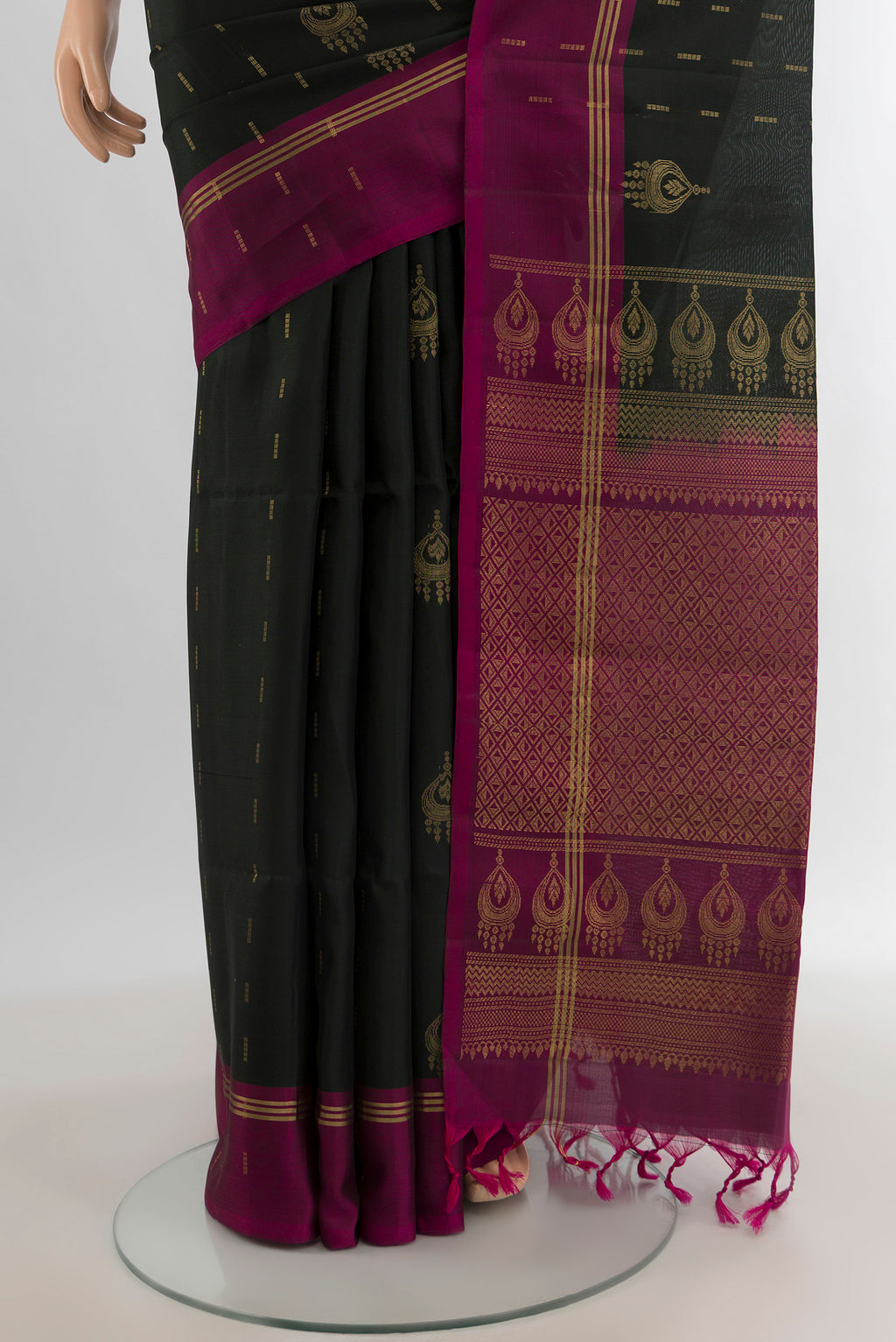 Pleats and pallu of Black Soft Silk Saree with Zari Butta on the body and Plain Border. 