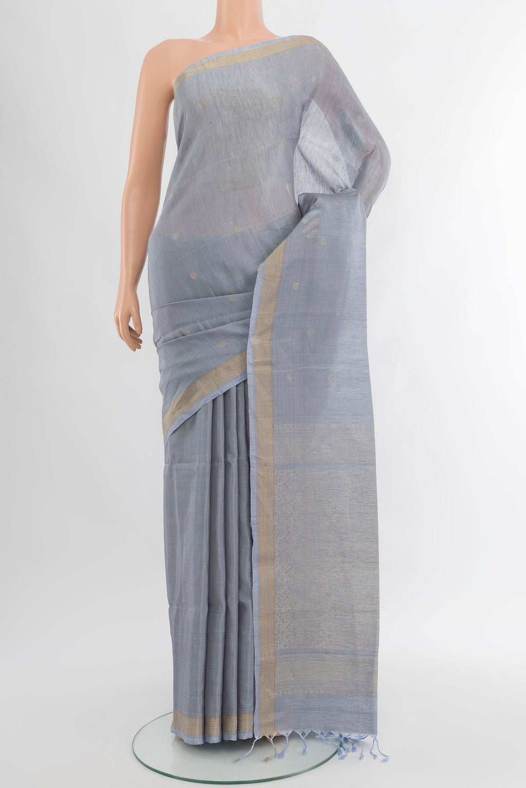 Blue Grey Soft Silk Saree with Zari Butta on the body and Silk Border.  displayed on a mannequin