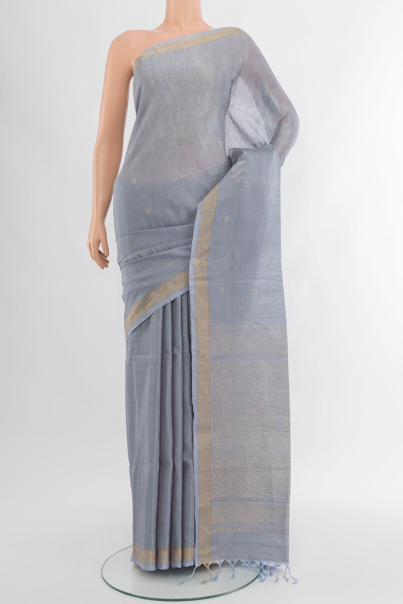 Blue Grey Soft Silk Saree with Zari Butta on the body and Silk Border.  displayed on a mannequin