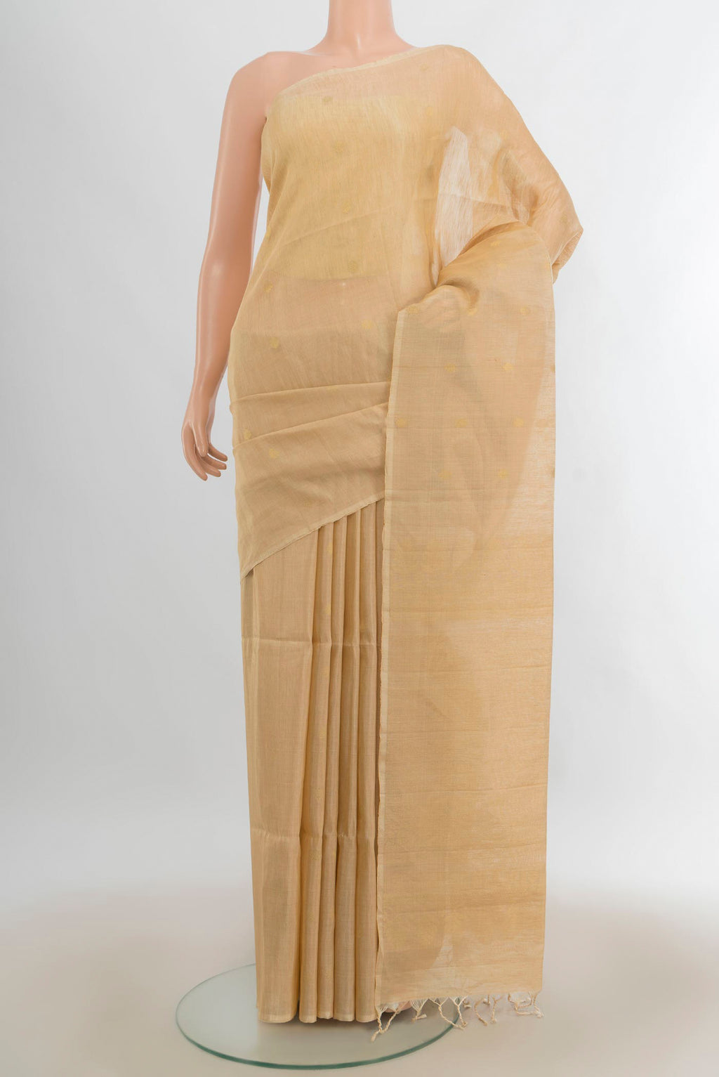 Golden Soft Saree with Zari Butta on the body and Silk Border.  displayed on a mannequin