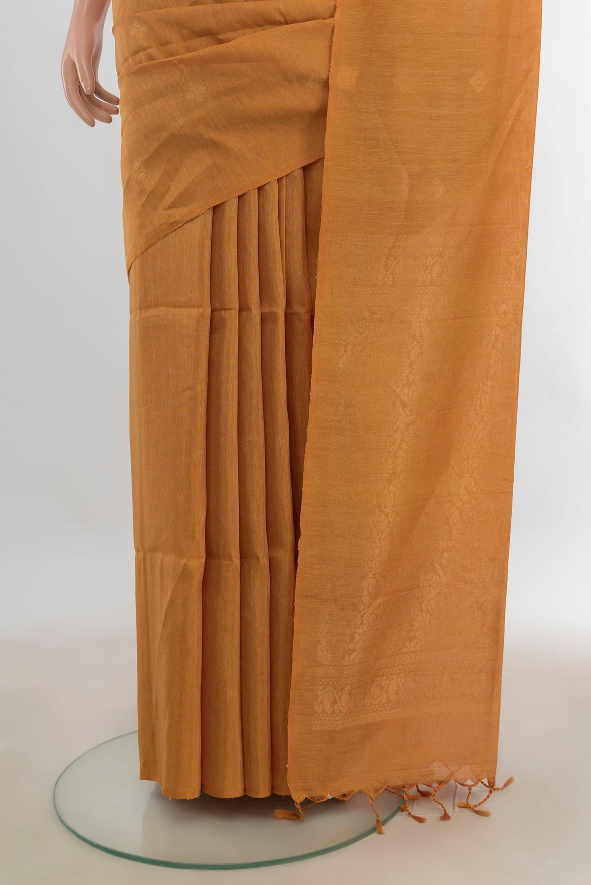 Pleats and pallu of Brown Soft Saree with Zari Butta on the body and Silk Border. 