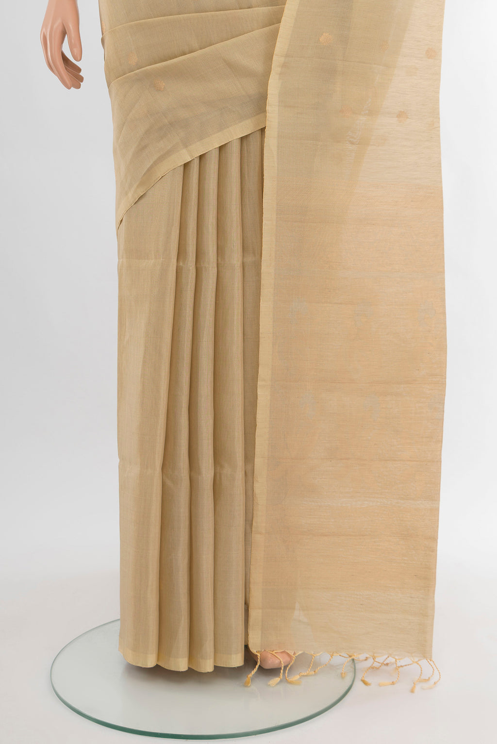 Pleats and pallu of Cream Soft Silk Saree with Zari Butta on the body and Silk Border. 