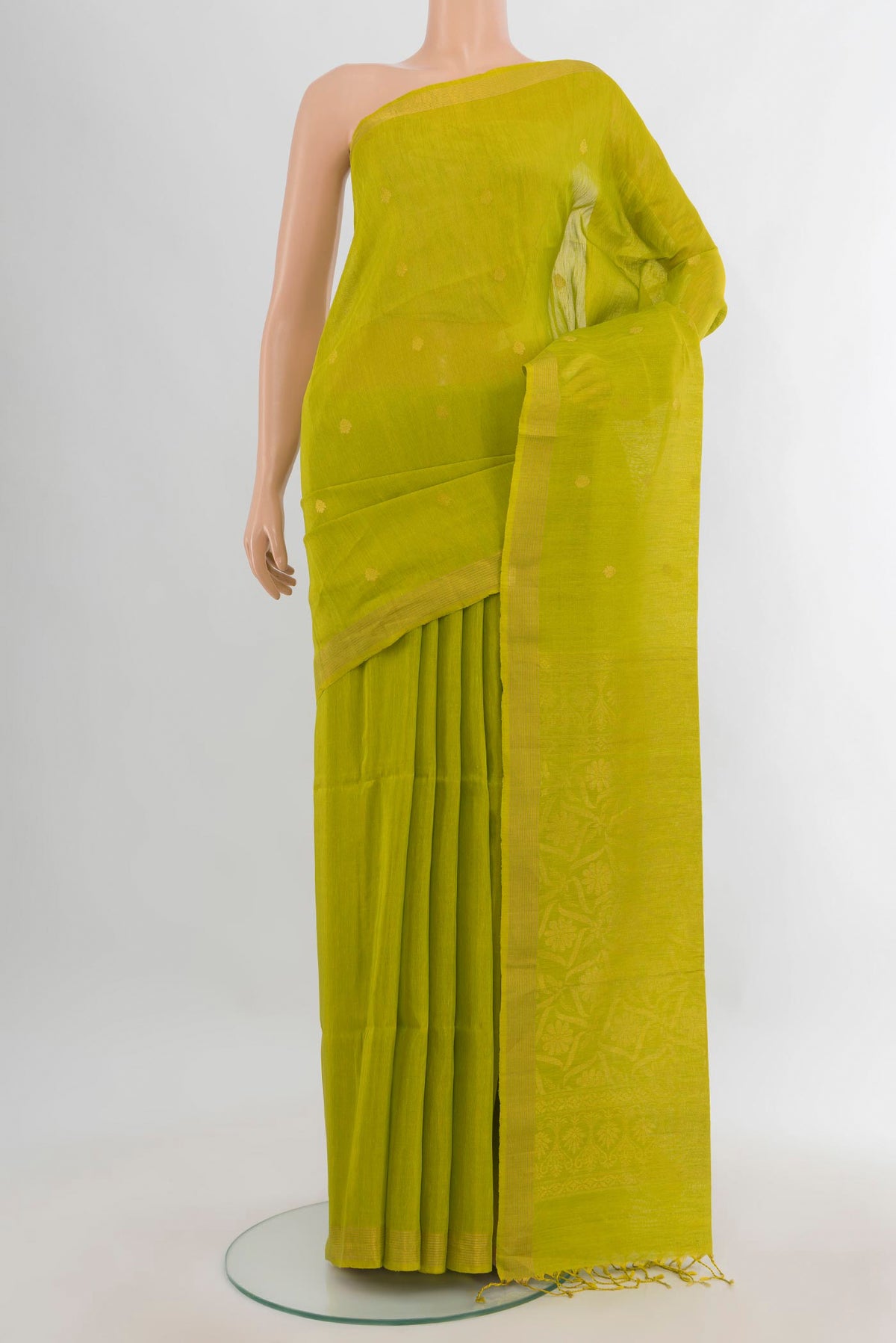Pure Silk Parrot Green Soft Saree with Zari Butta on the body and Zari Border.  displayed on a mannequin