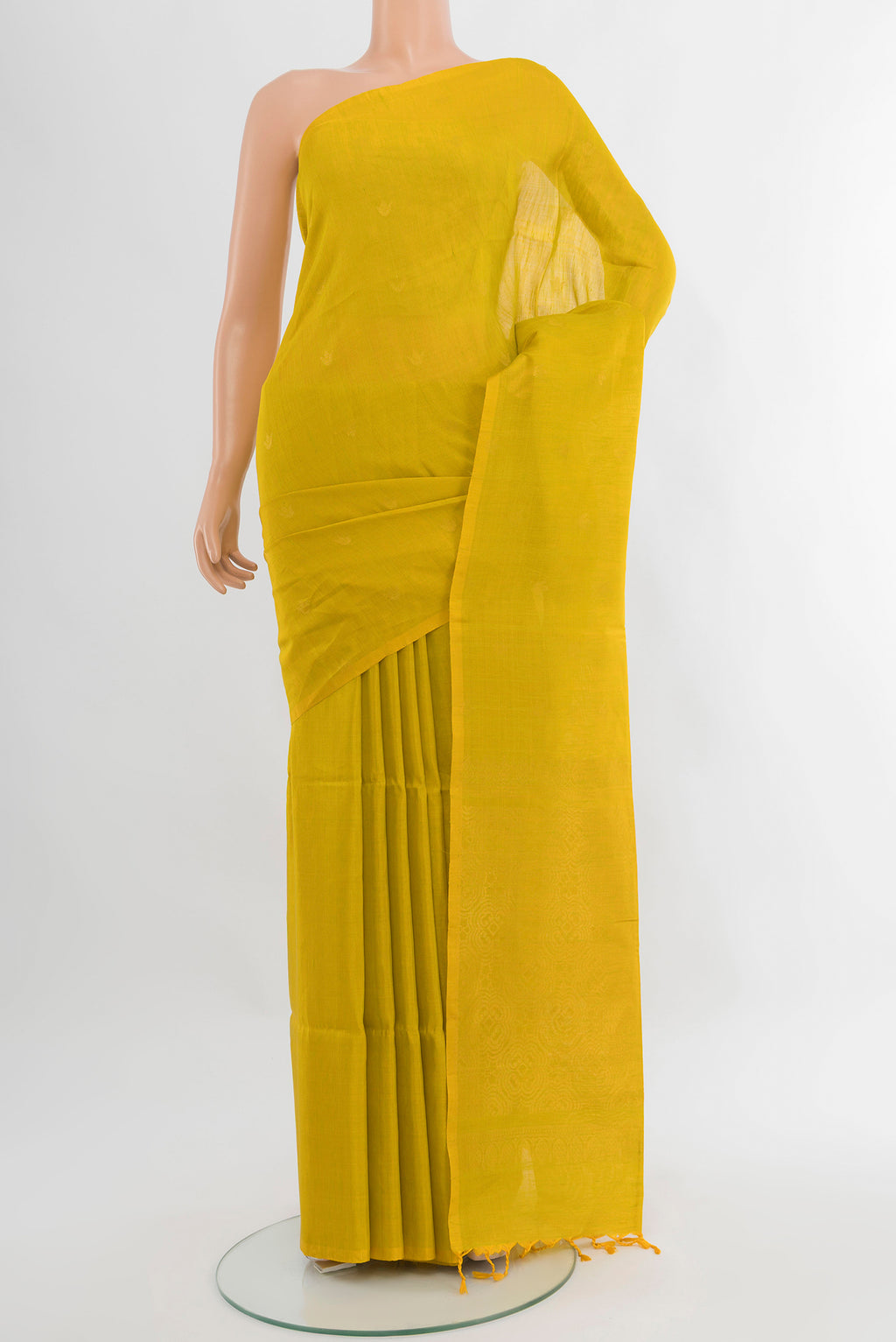 Light Green Soft Silk Saree with Zari Butta on the body and Without Border.  displayed on a mannequin