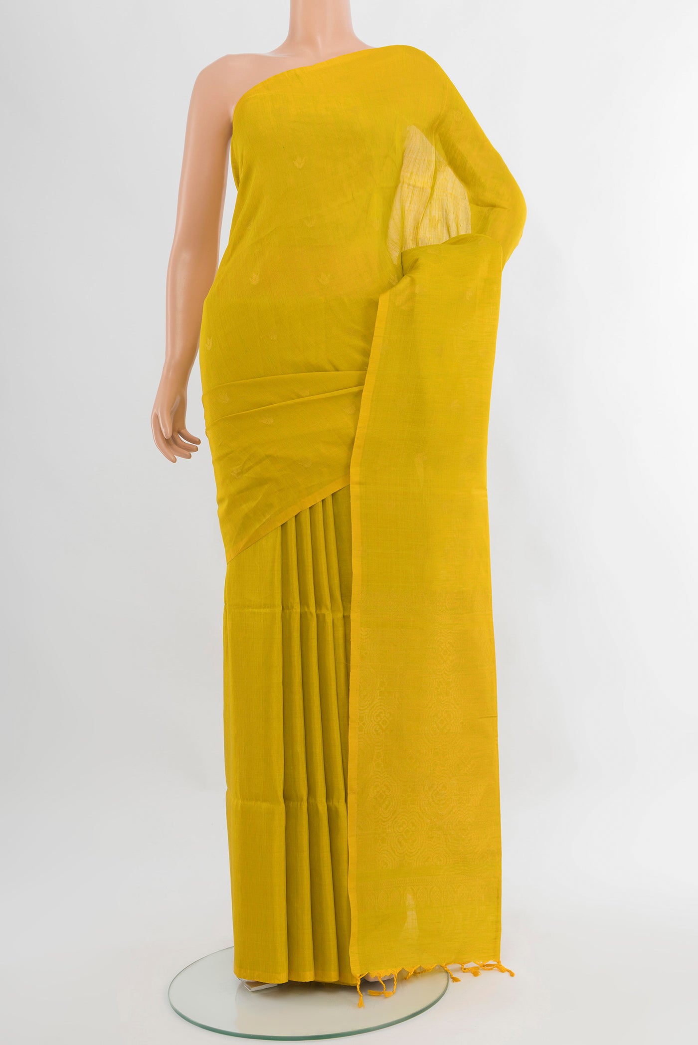 Light Green Soft Silk Saree with Zari Butta on the body and Without Border.  displayed on a mannequin