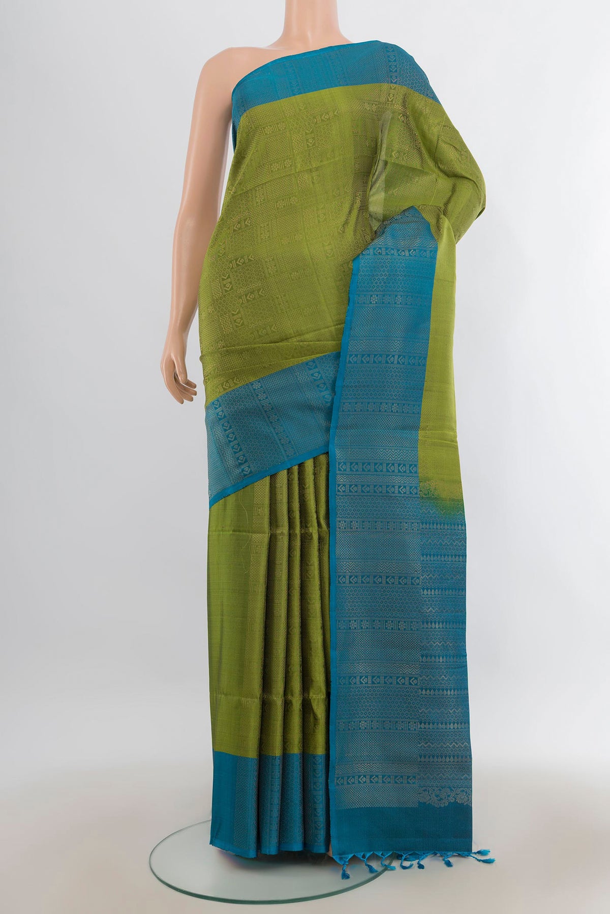 Pure Silk Mehandi Green Soft Saree with Zari Brocade on the body and Plain Border.  displayed on a mannequin