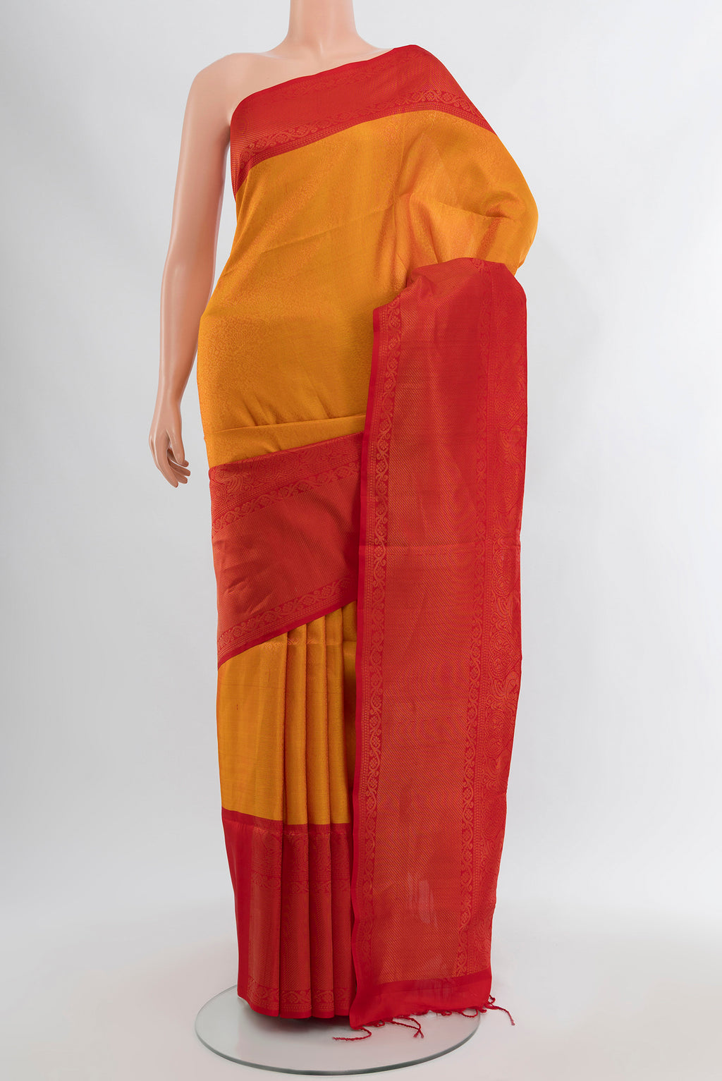 Mustard Soft Silk Saree with Zari Brocade on the body and Zari Border.  displayed on a mannequin