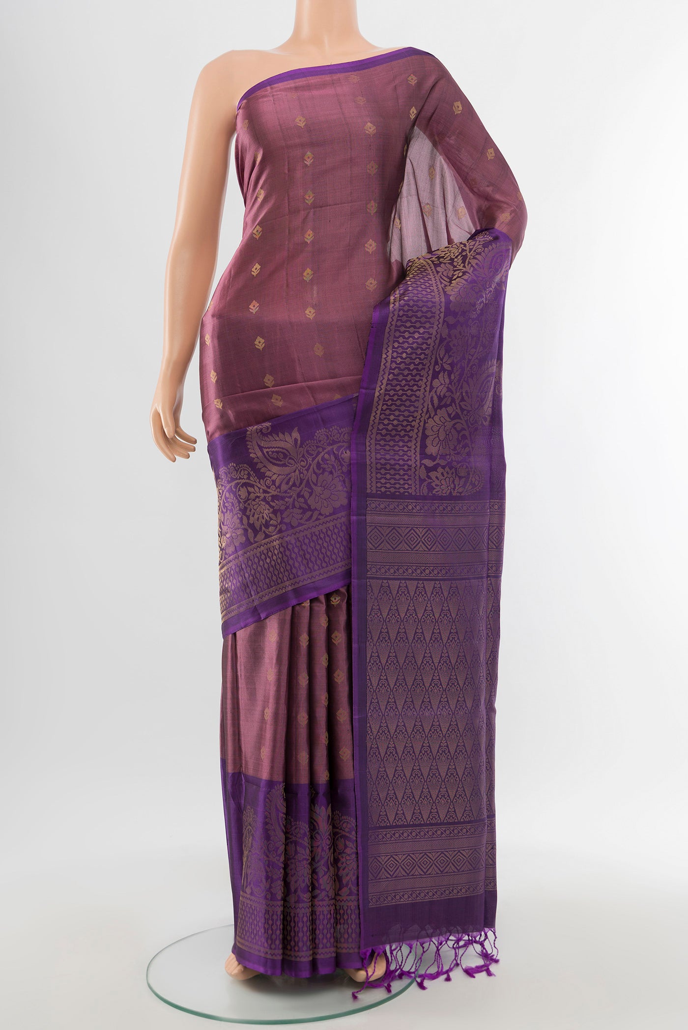 Bronze Soft Silk Saree with Zari Butta on the body and Silk Border.  displayed on a mannequin