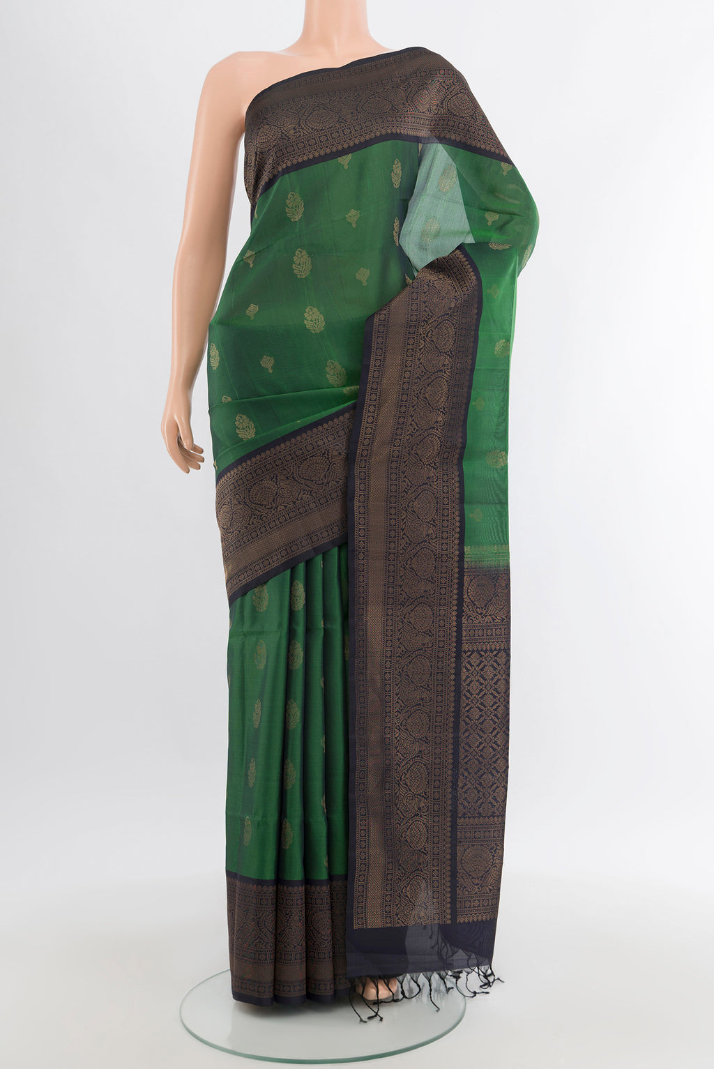 Green Soft Silk Saree with Zari Butta on the body and Zari Border.  displayed on a mannequin