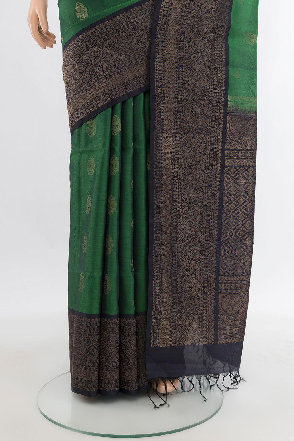 Pleats and pallu of Green Soft Silk Saree with Zari Butta on the body and Zari Border. 