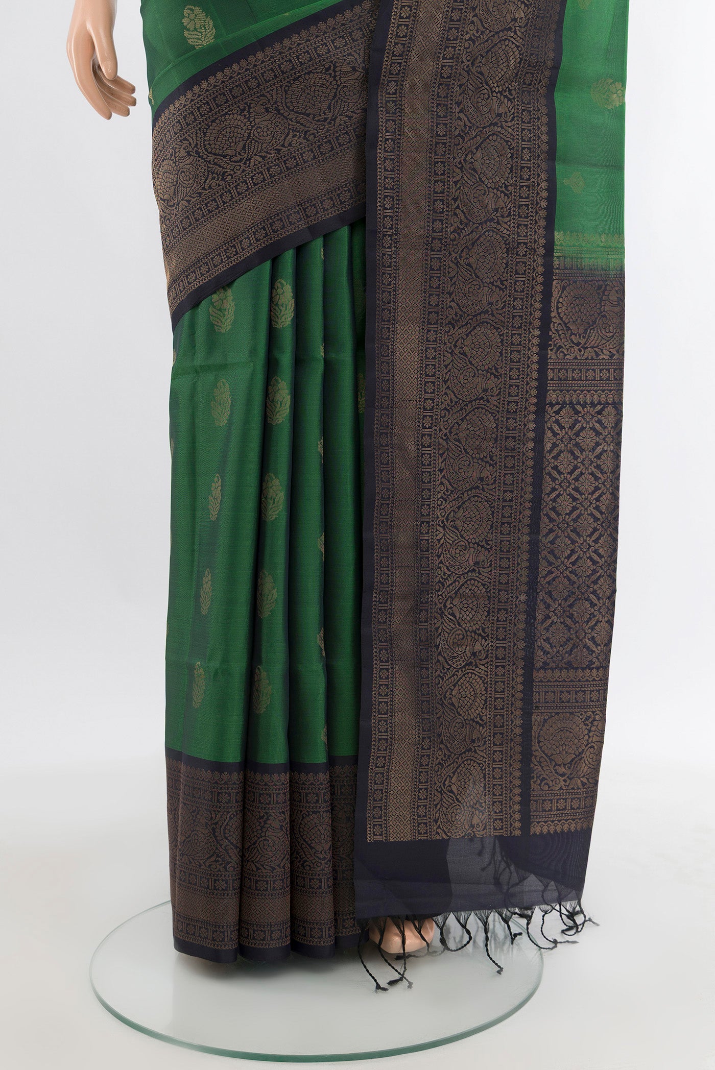 Pleats and pallu of Green Soft Silk Saree with Zari Butta on the body and Zari Border. 