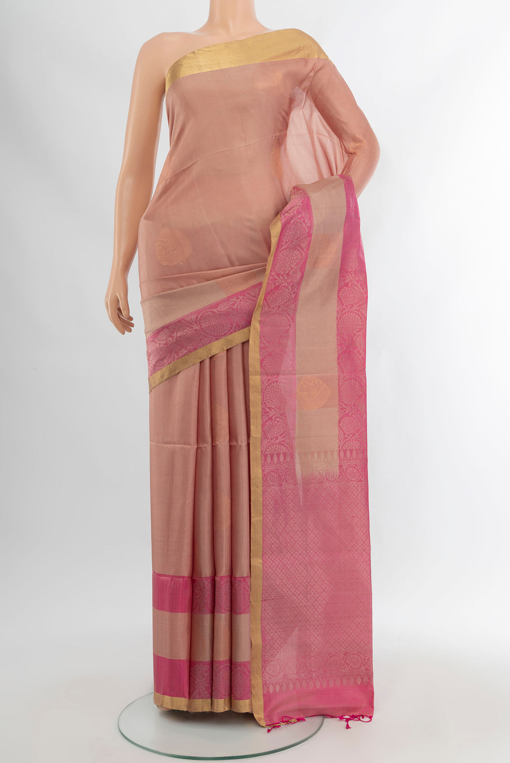 Bronze Soft Silk Saree with Zari Butta on the body and Silk Border.  displayed on a mannequin