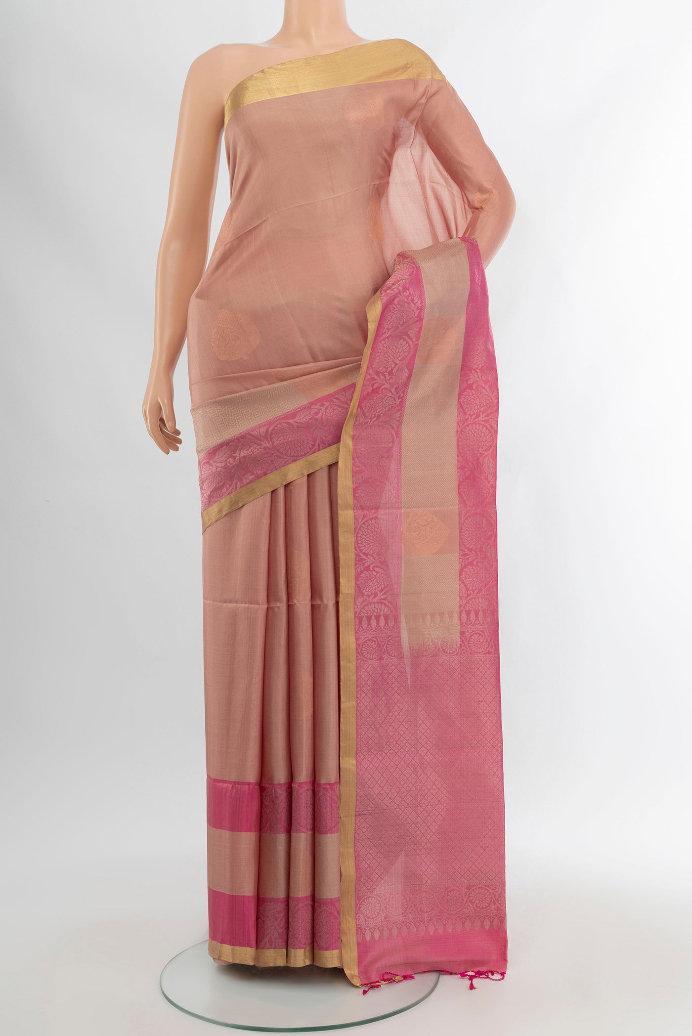 Bronze Soft Silk Saree with Zari Butta on the body and Silk Border.  displayed on a mannequin