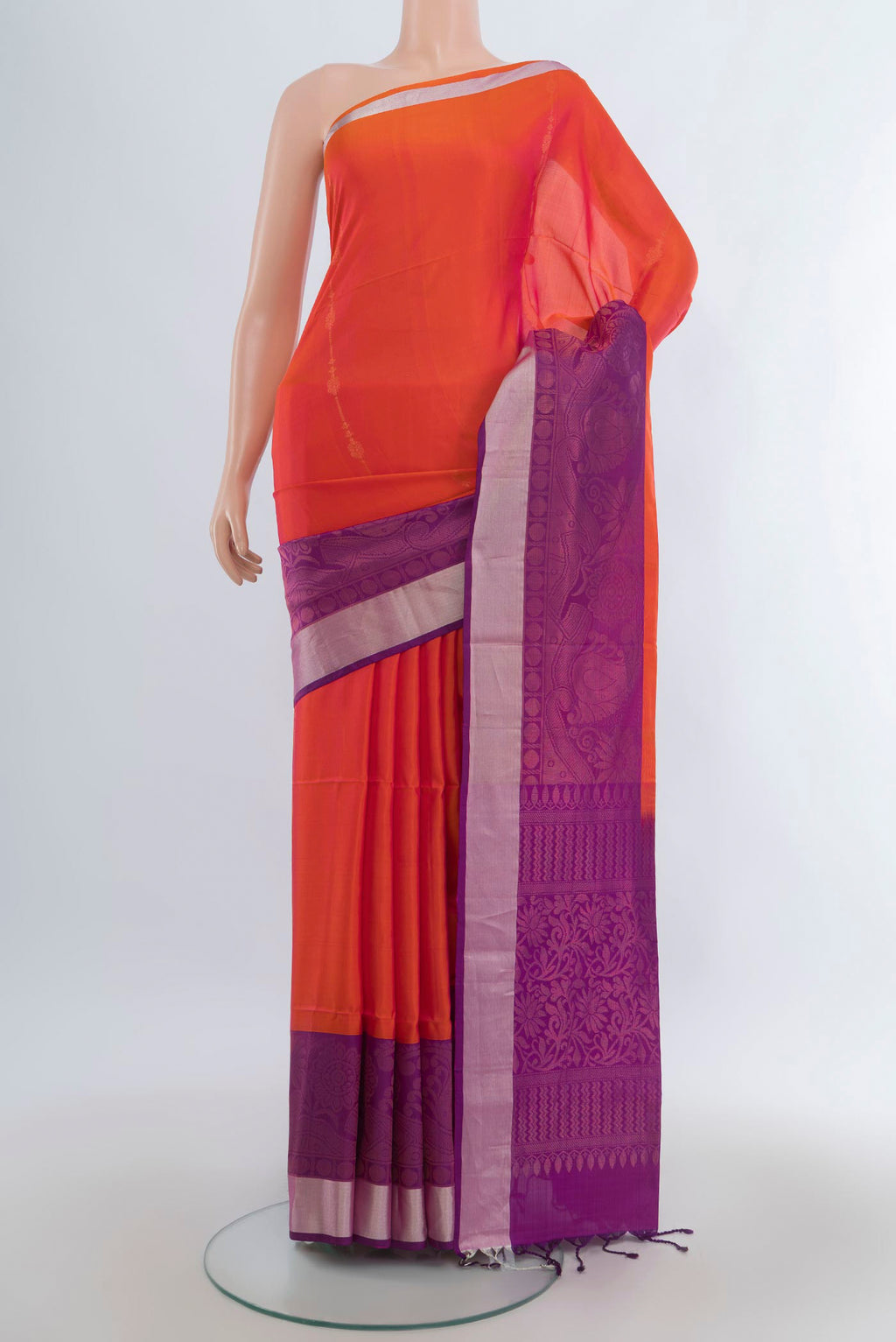 Pure Silk Brick Orange Soft Saree with Zari Butta on the body and Zari Border.  displayed on a mannequin