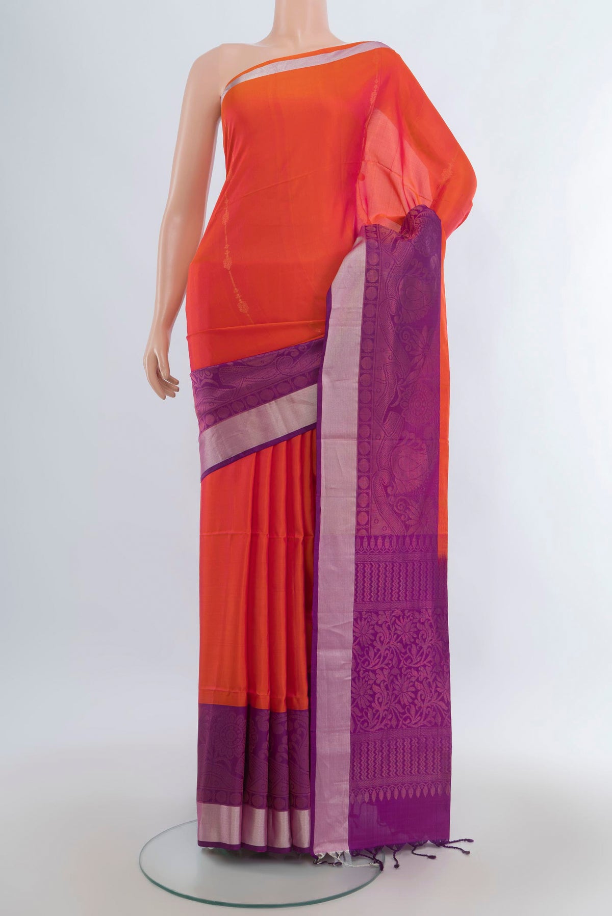 Pure Silk Brick Orange Soft Saree with Zari Butta on the body and Zari Border.  displayed on a mannequin