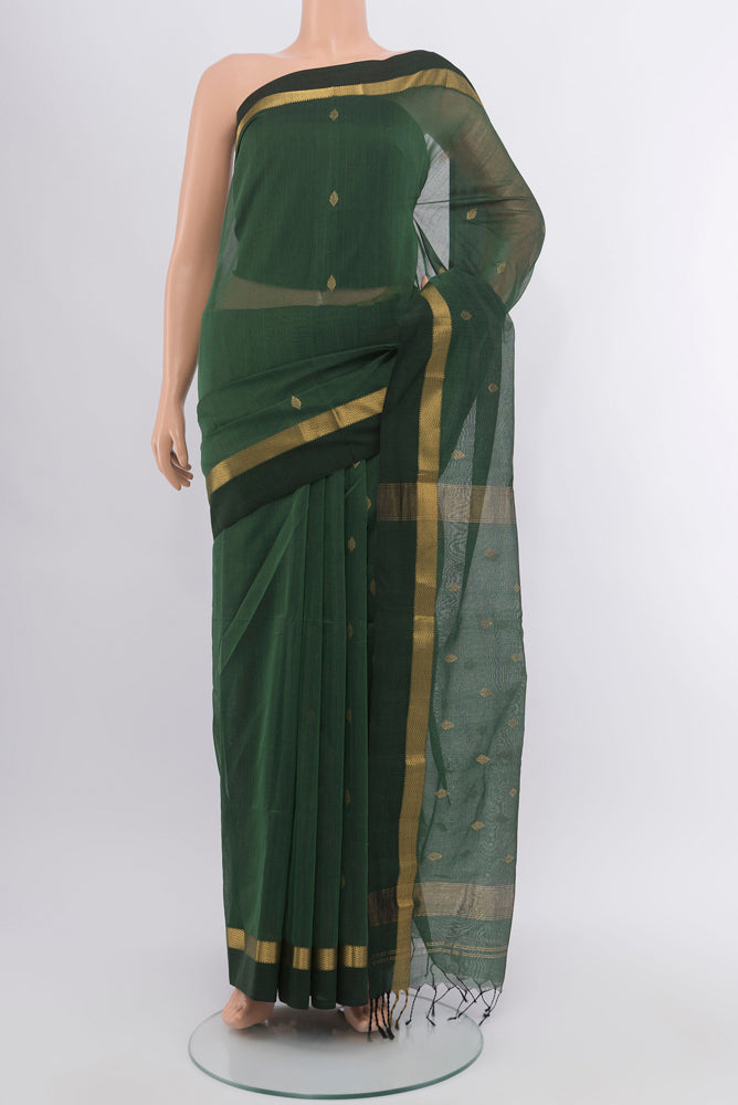 Mint Green Maheshwari Silk Cotton Saree with Zari Butta on the body and Silk Border.  displayed on a mannequin