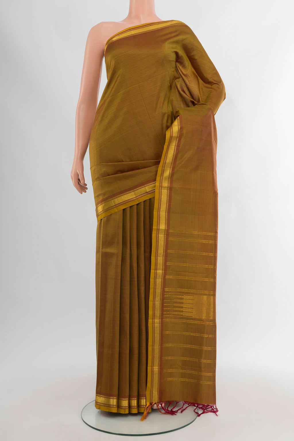 Mehandi Green Kanjivaram Silk Saree with Plain Body and Zari Border.  displayed on a mannequin