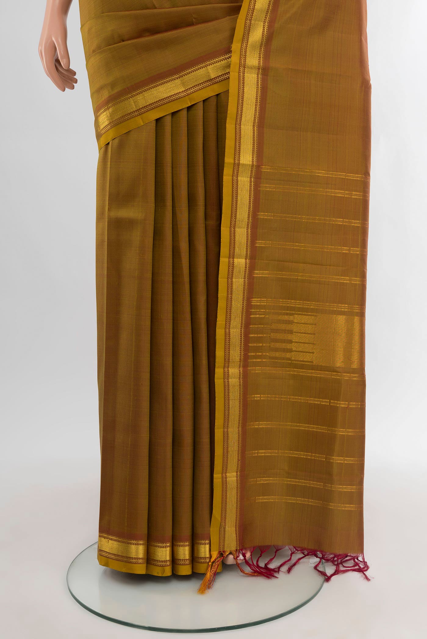 Pleats and pallu of Mehandi Green Kanjivaram Silk Saree with Plain Body and Zari Border. 