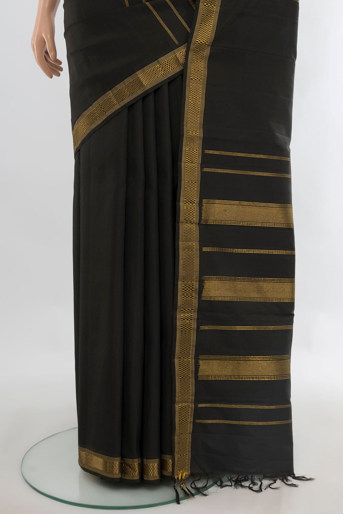 Pleats and pallu of Pure Silk Black Kanchipuram Saree with Stripes on the body and Zari Border. 