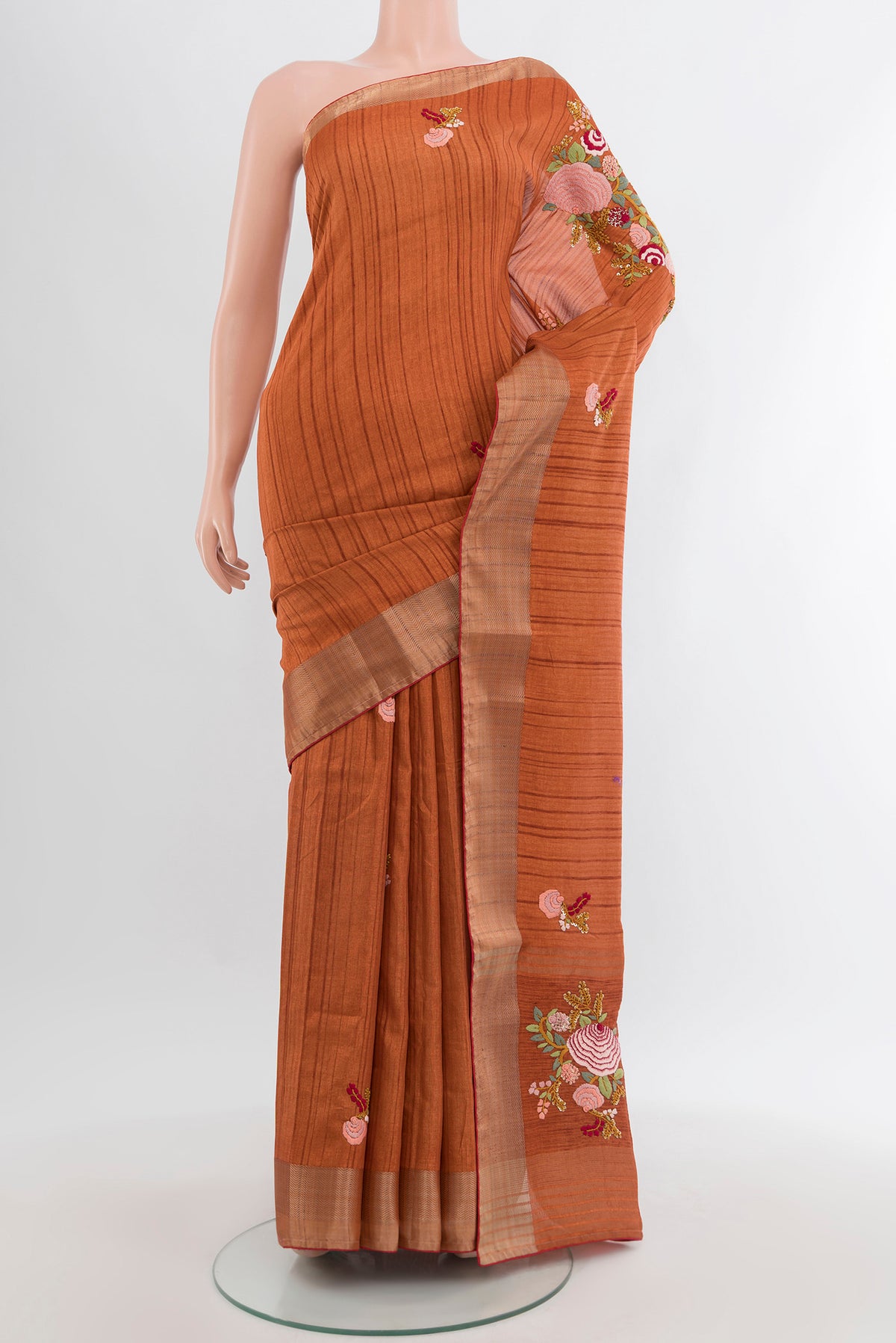 Rust Blended Art Silk Saree with Embroidery on the body and Zari Border.  displayed on a mannequin