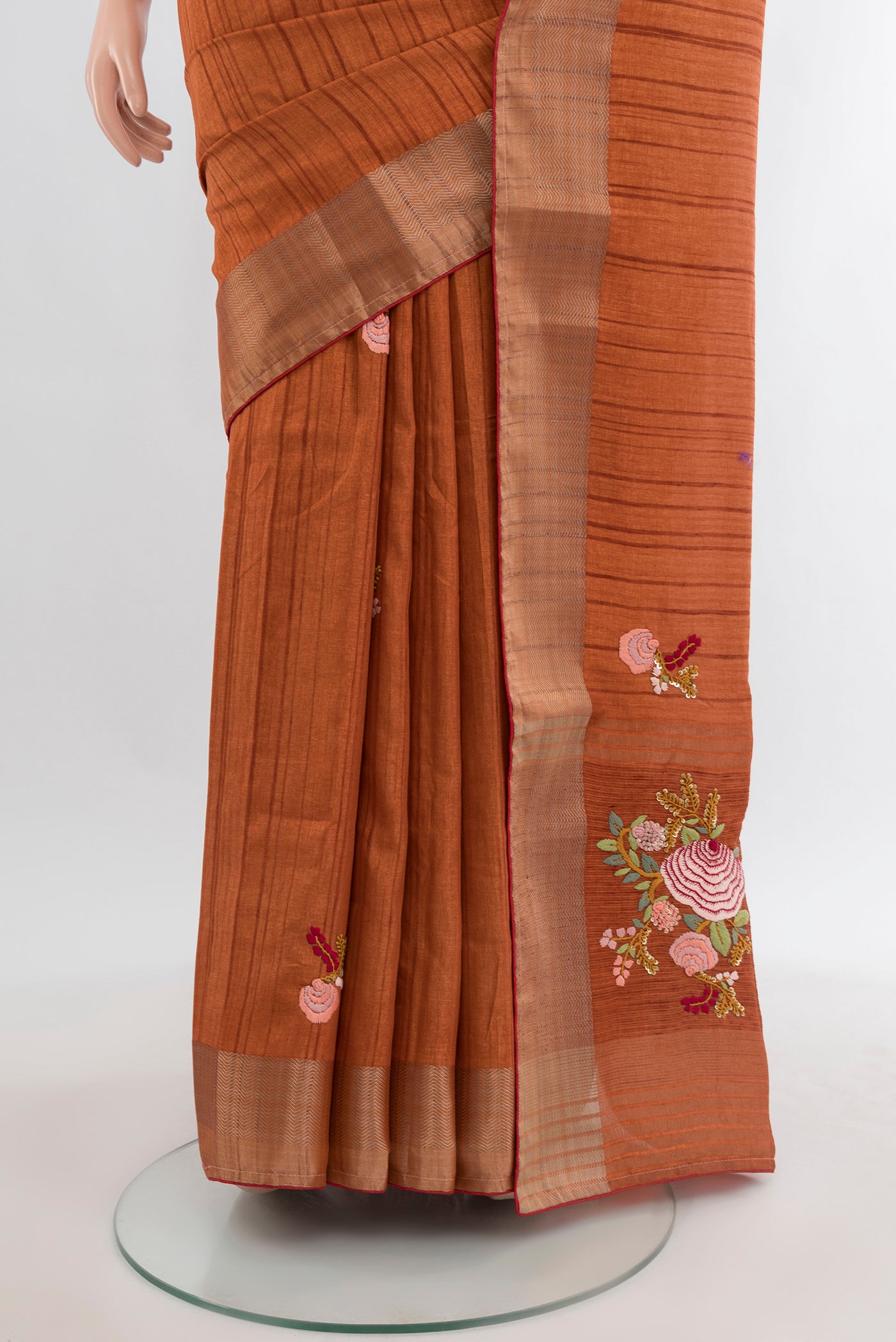 Pleats and pallu of Rust Blended Art Silk Saree with Embroidery on the body and Zari Border. 