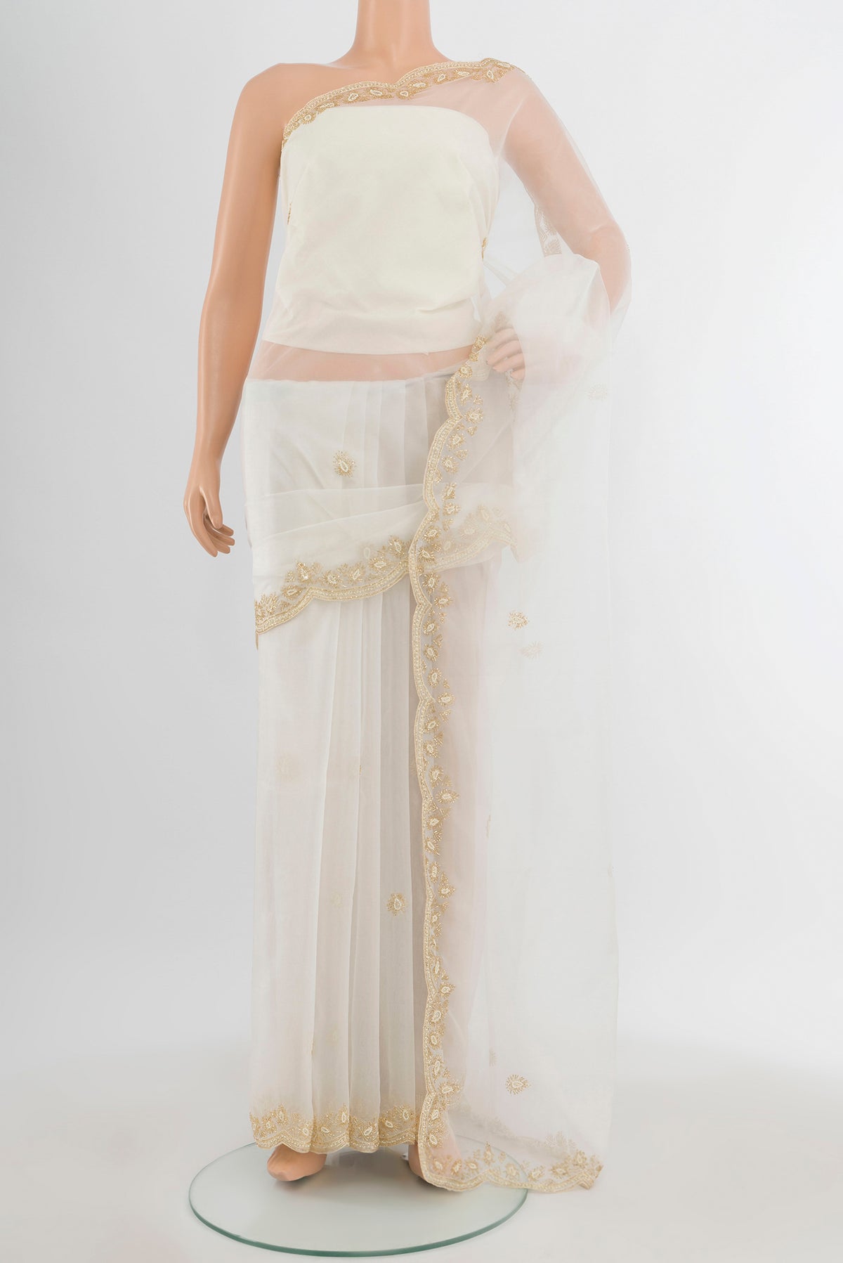 Cream Embroidery Net Saree with Embroidery on the body and Silk Border.  displayed on a mannequin