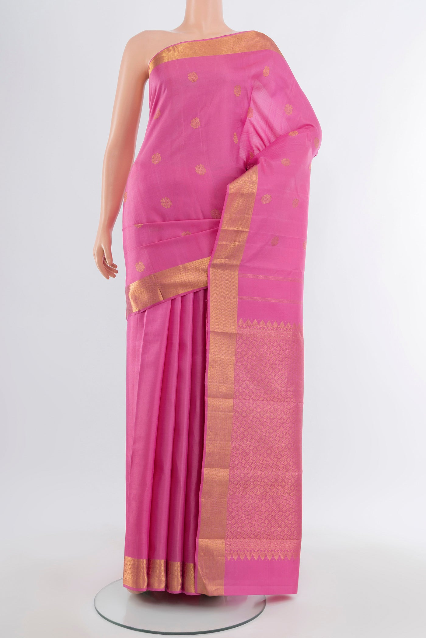 Rose Gold Kanjivaram Silk Saree with Zari Butta on the body and Silk Border.  displayed on a mannequin