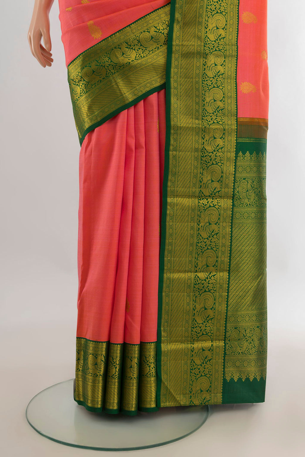 Pleats and pallu of Pure Silk Coral Kanjivaram Saree with Zari Butta on the body and Zari Border. 