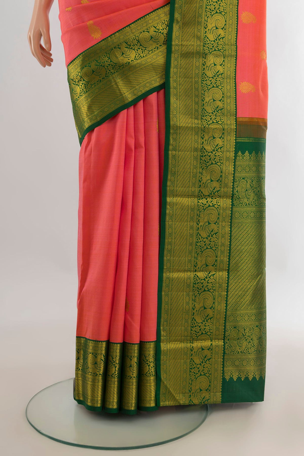 Pleats and pallu of Pure Silk Coral Kanjivaram Saree with Zari Butta on the body and Zari Border. 