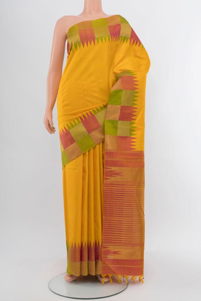 Pure Silk Pure Zari Yellow Kanjivaram Saree with Zari Butta on the body and Silk Border.  displayed on a mannequin