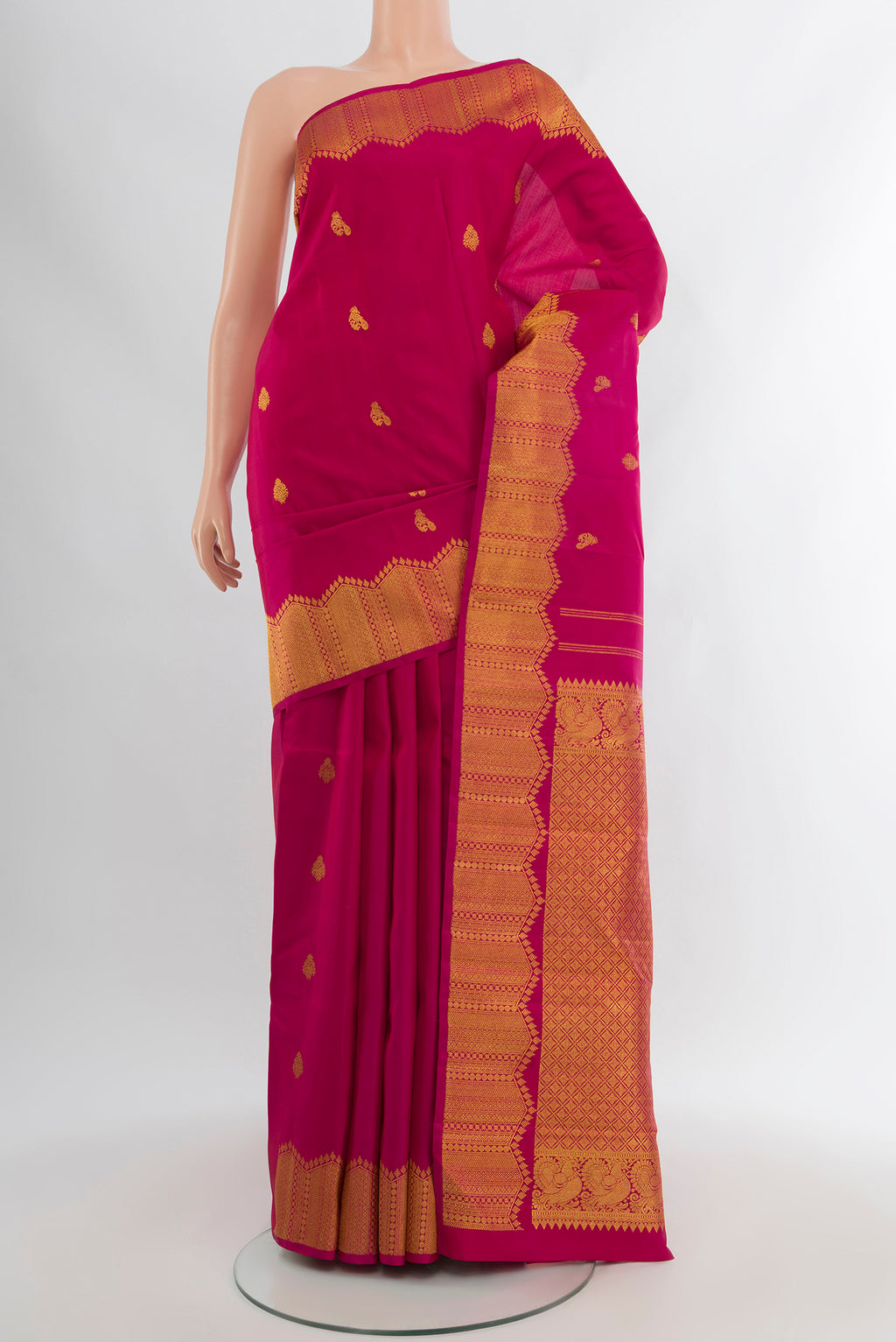 Pure Silk Pure Zari Dark Pink Kanjivaram Saree with Zari Butta on the body and Silk Border.  displayed on a mannequin