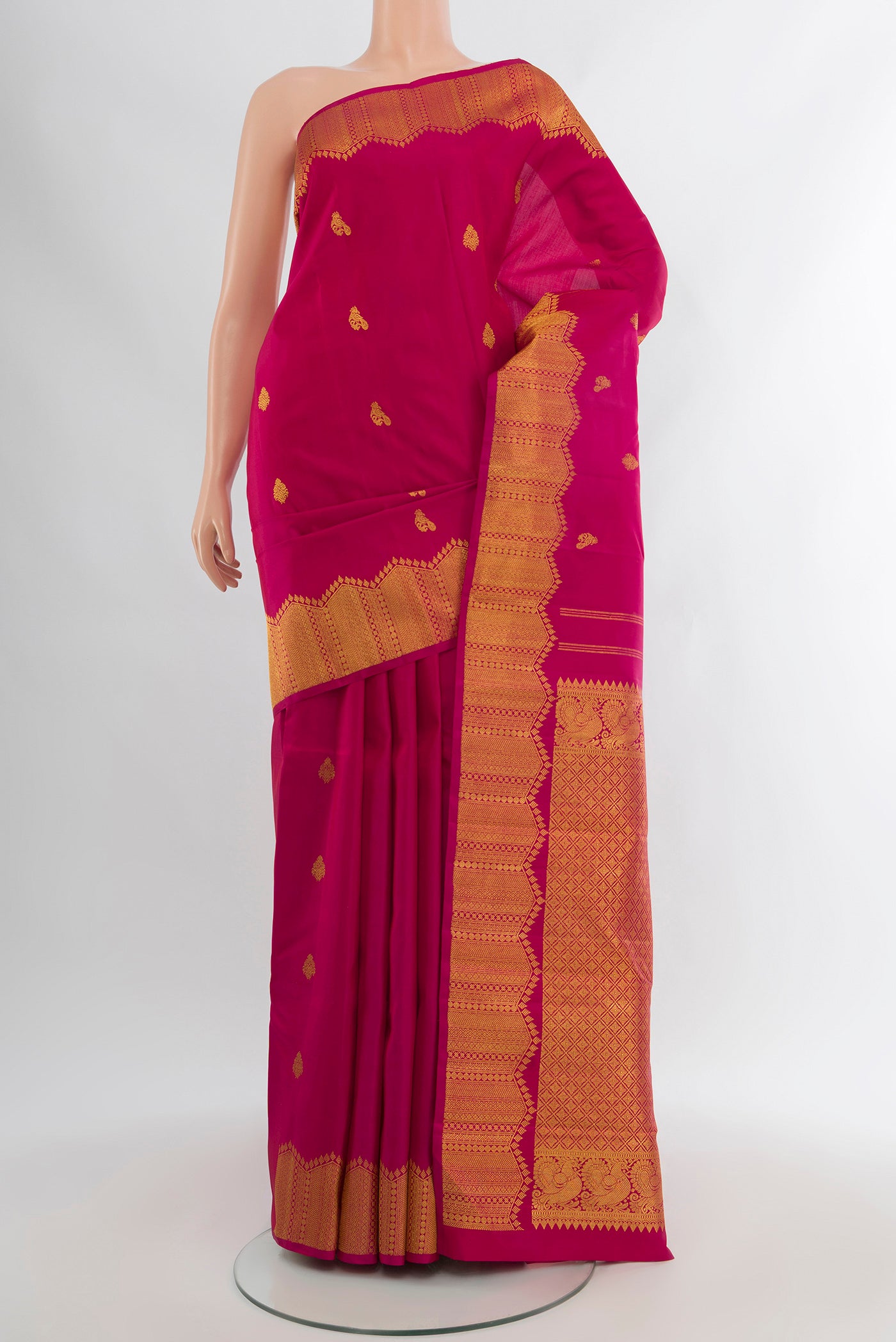 Pure Silk Pure Zari Dark Pink Kanjivaram Saree with Zari Butta on the body and Silk Border.  displayed on a mannequin