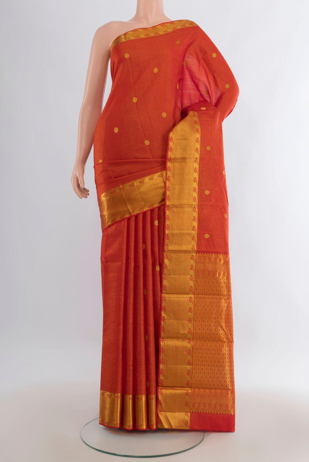 Pure Silk Brick Orange Kanjivaram Saree with Checked design on the body and Zari Border.  displayed on a mannequin