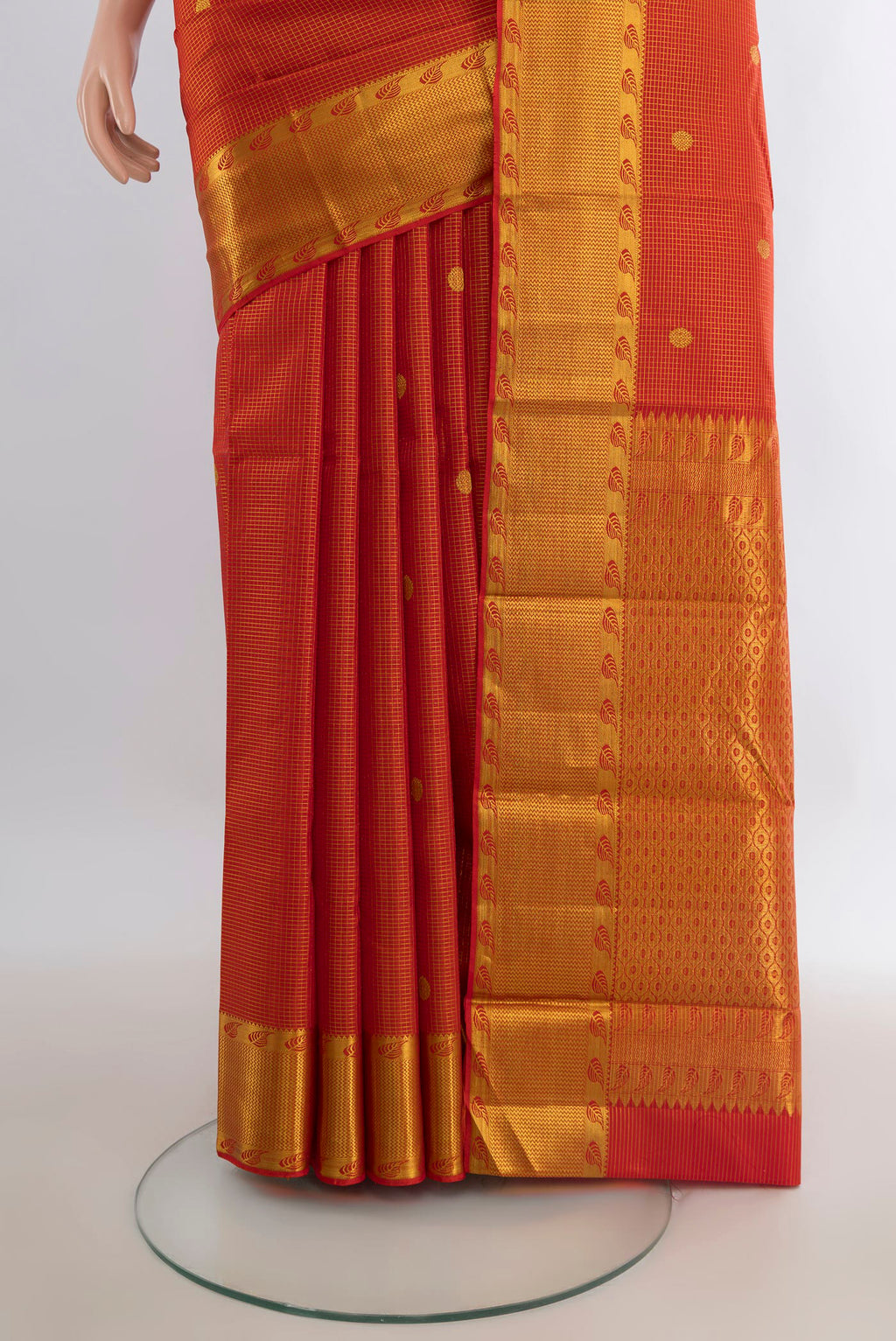 Pleats and pallu of Pure Silk Brick Orange Kanjivaram Saree with Checked design on the body and Zari Border. 