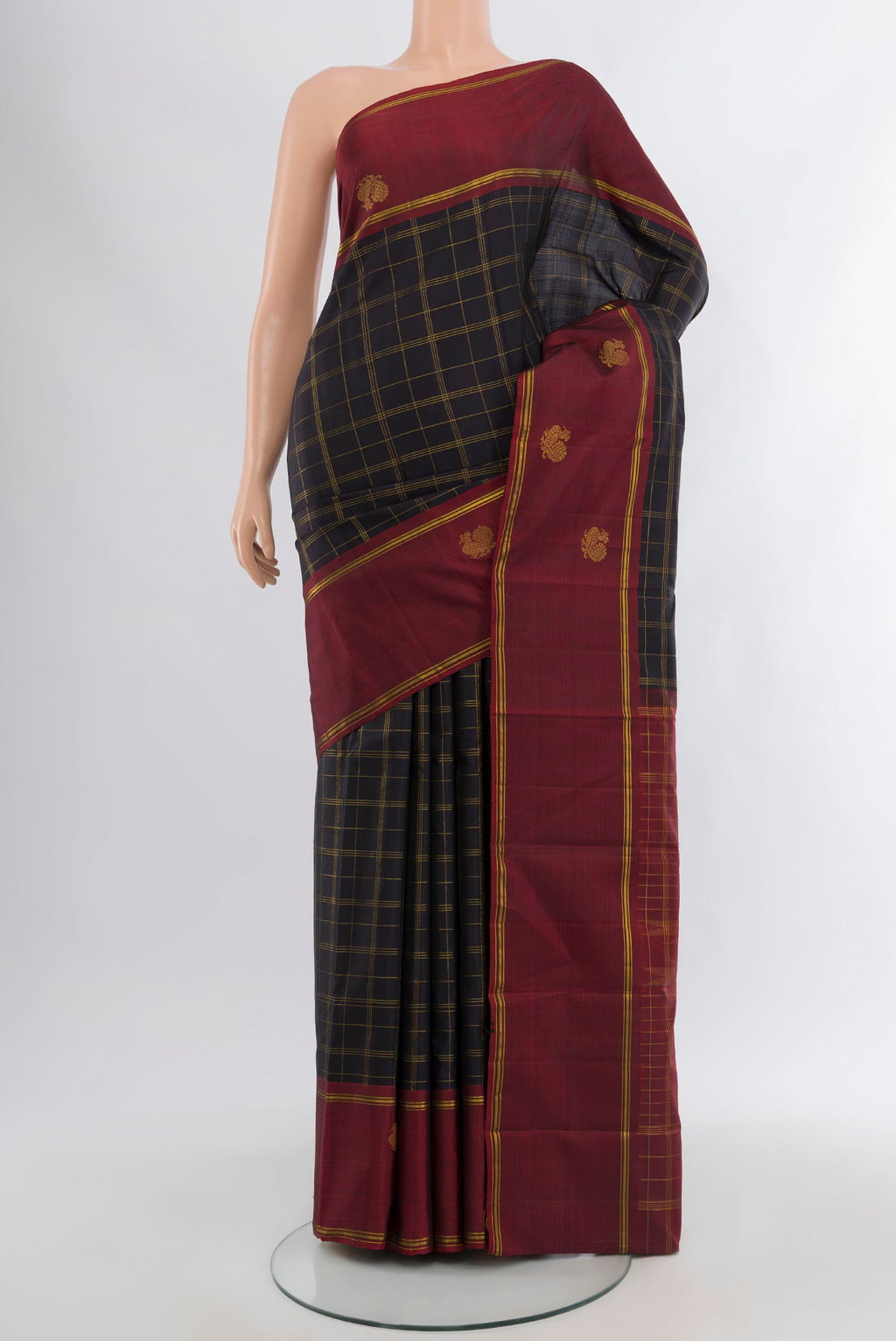 Black Kanchipuram Silk Saree with Checked design on the body and Zari Border.  displayed on a mannequin