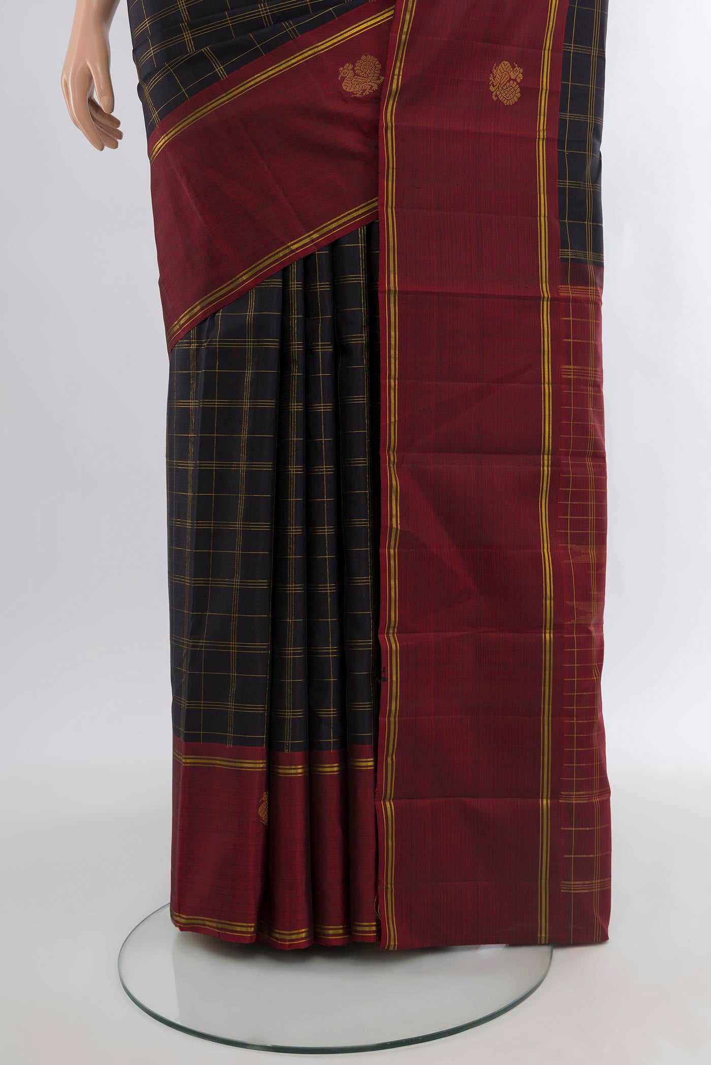 Pleats and pallu of Black Kanchipuram Silk Saree with Checked design on the body and Zari Border. 