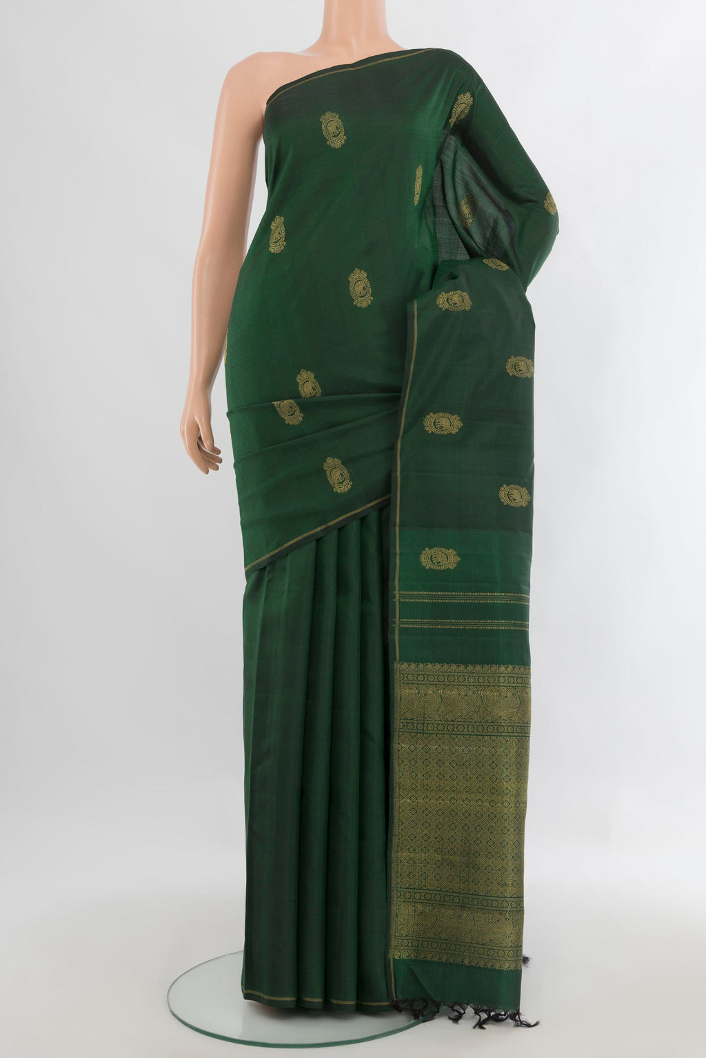 Pure Silk Pure Zari Bottle Green Kanchipuram Saree with Zari Butta on the body and Thin Zari Line.  displayed on a mannequin